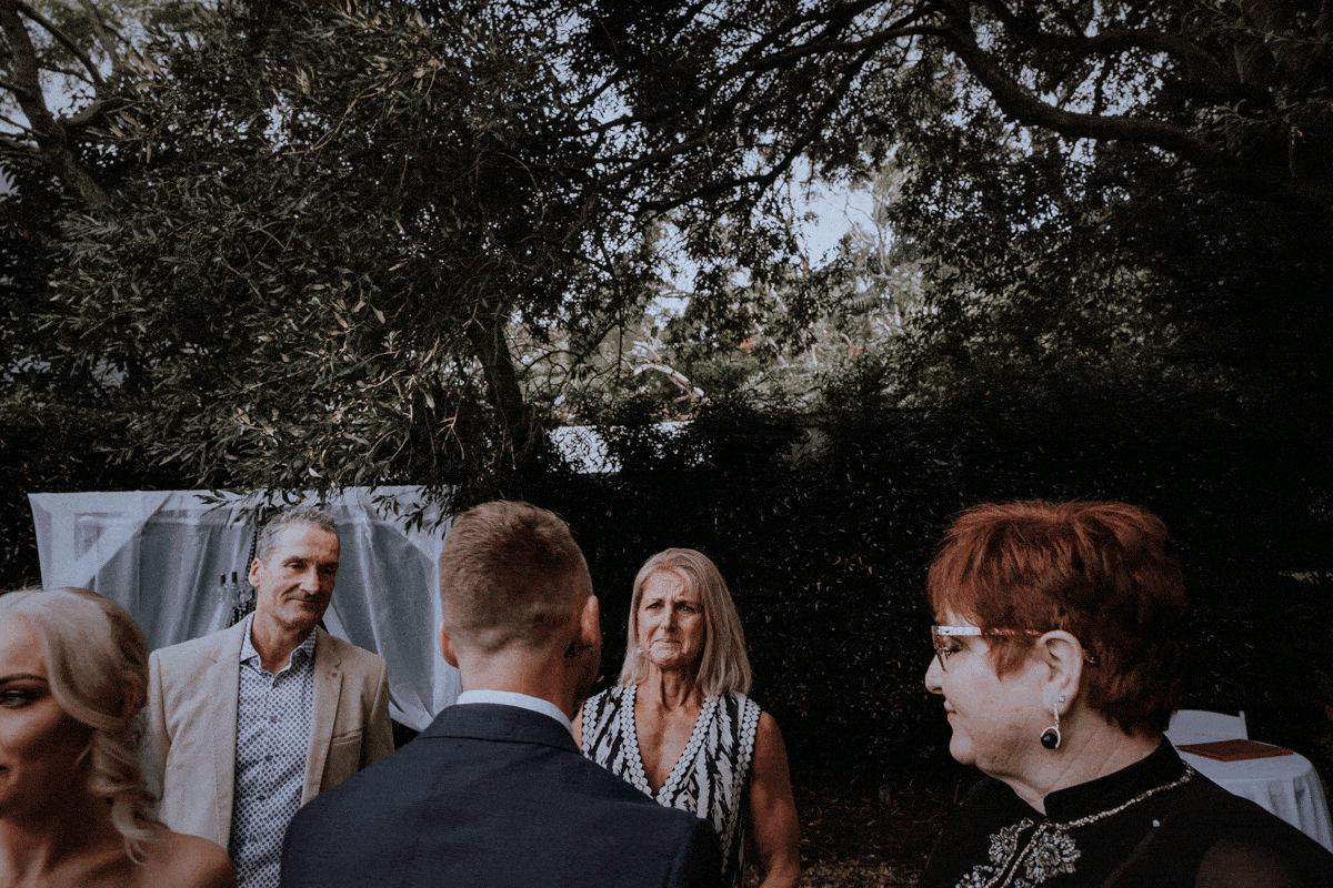An emotional mum embraces her newly married son after his surprise wedding in Sydney