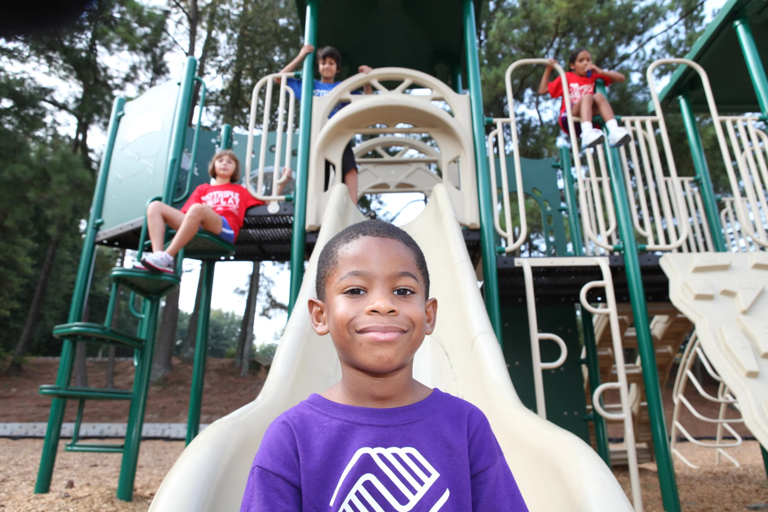 smiling-boy-on-slide.jpg