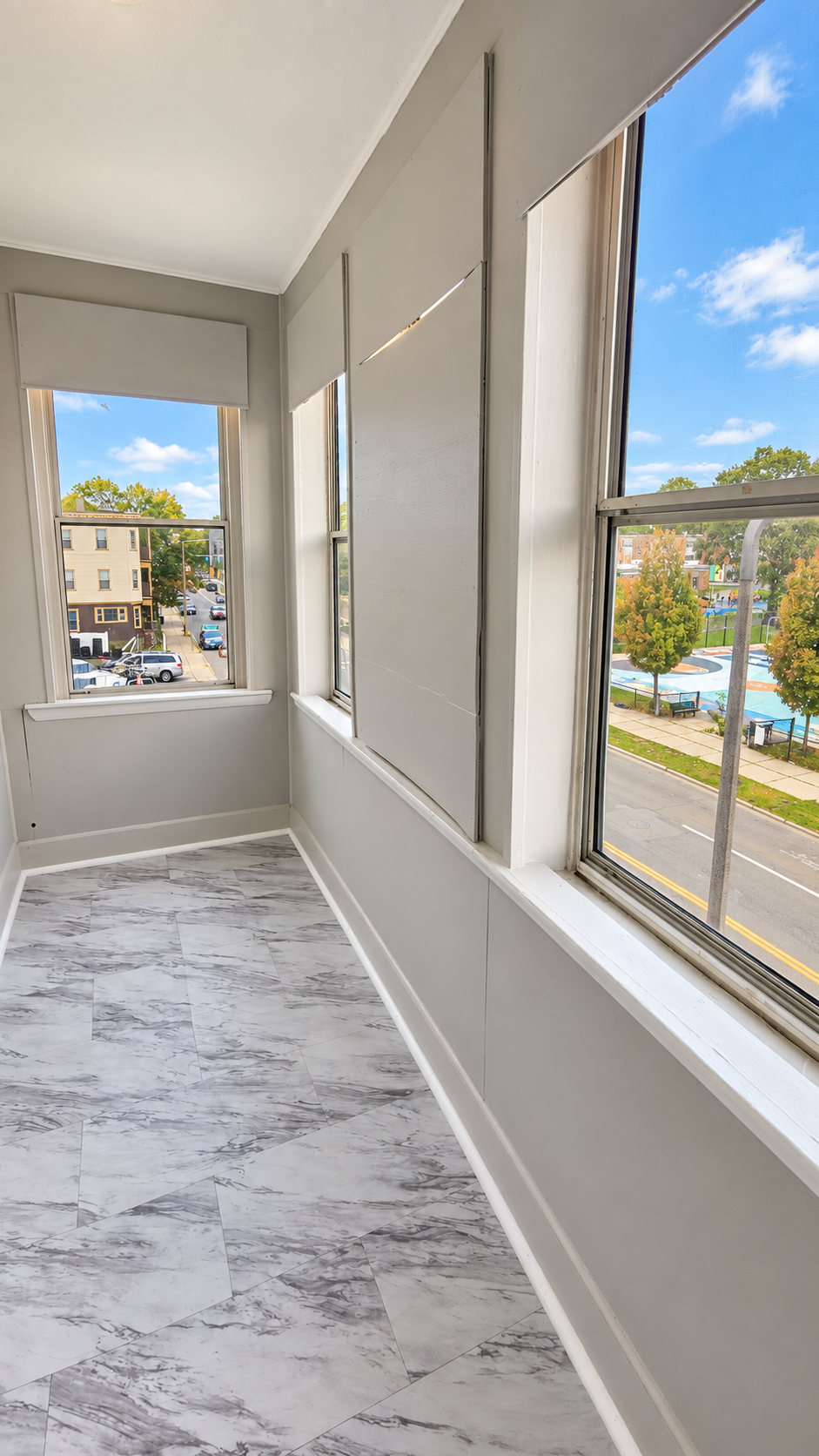 bright_gray_sunroom_with_urban_views.png
