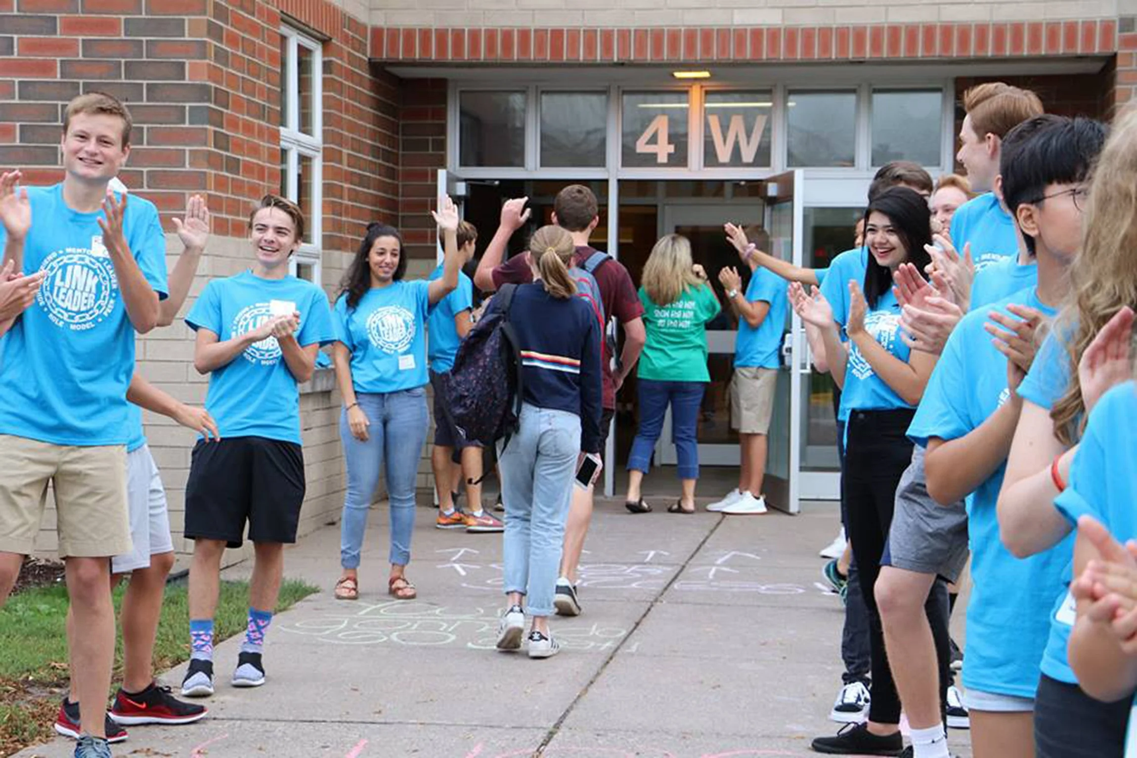 High school mentors, part of the Link Crew, greet new students on the first day of school in 2017.