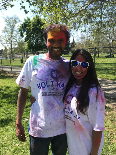 Sheenika and her husband covered in colored powder to celebrate the Indian festival of Holi.