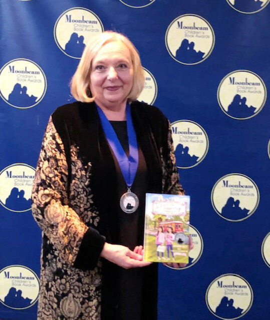 In Michigan to accept a Moonbeam Award in the category of Children's Mystery books for Case of the Missing Poodle. 