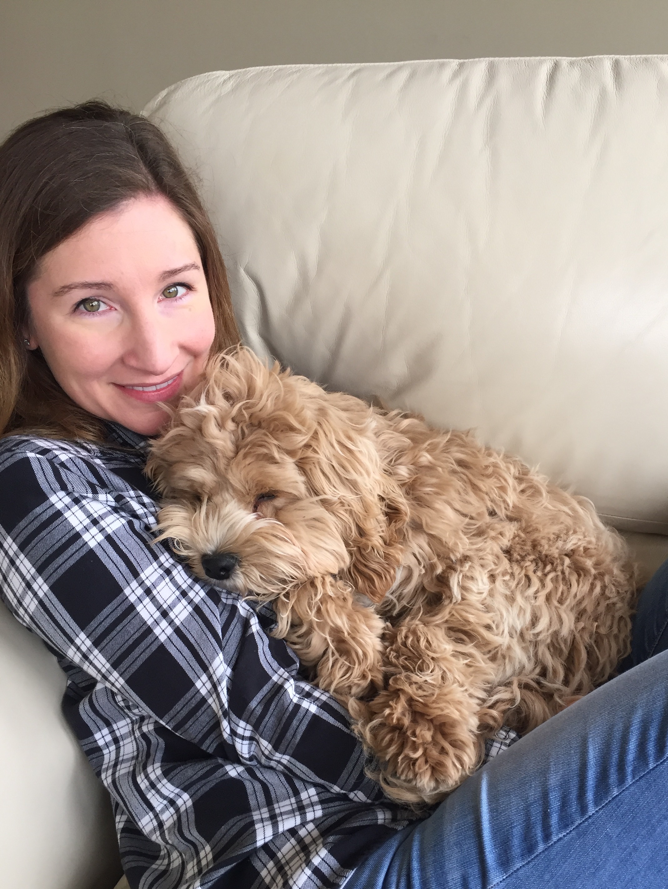 Emily and her dog, Eli, snuggling on the couch!