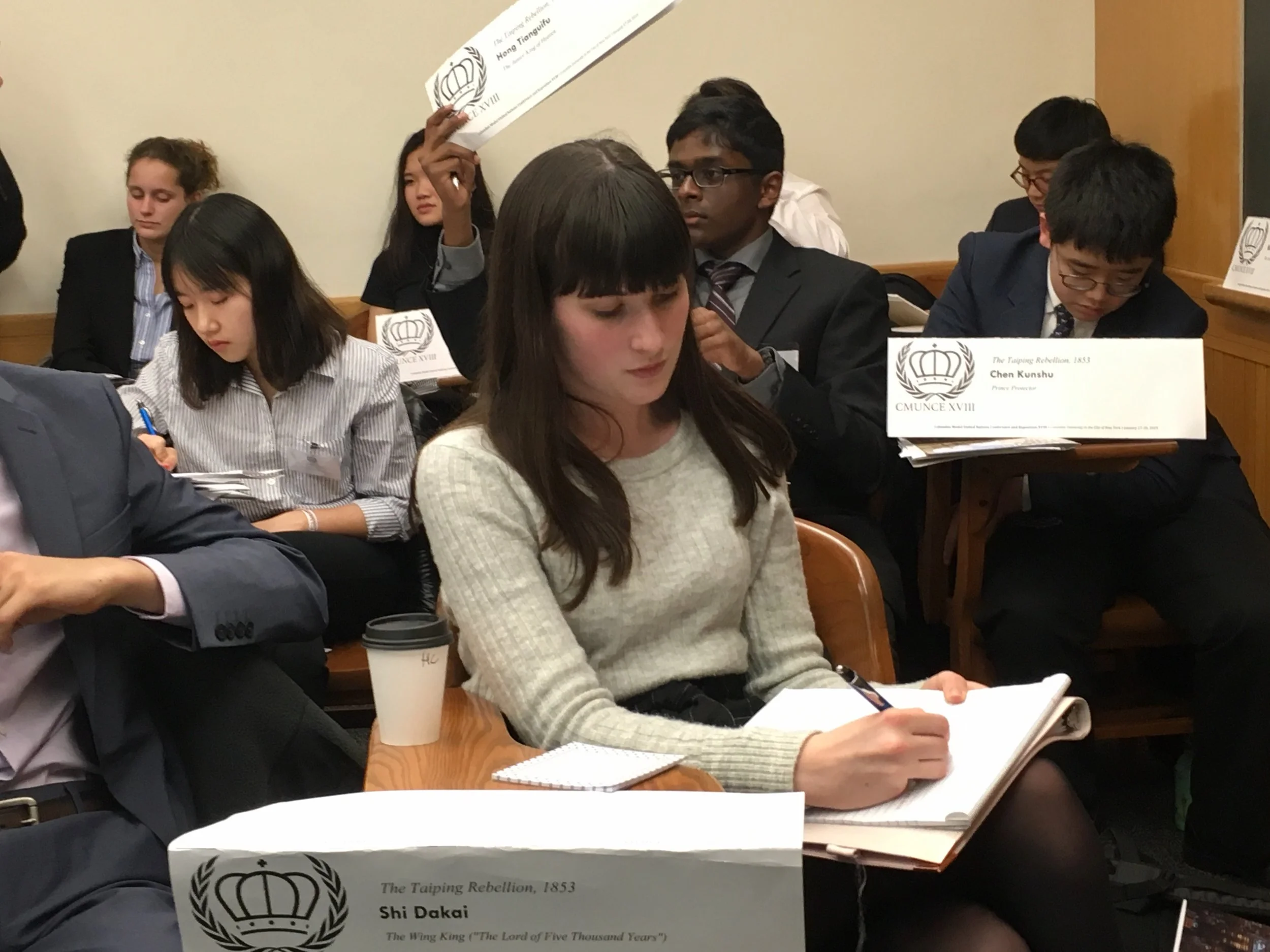 Abigail Reardon composes a crisis note during a moderated caucus on the Taiping Rebellion. Crisis notes are a way to exercise powers outside of traditional debate.