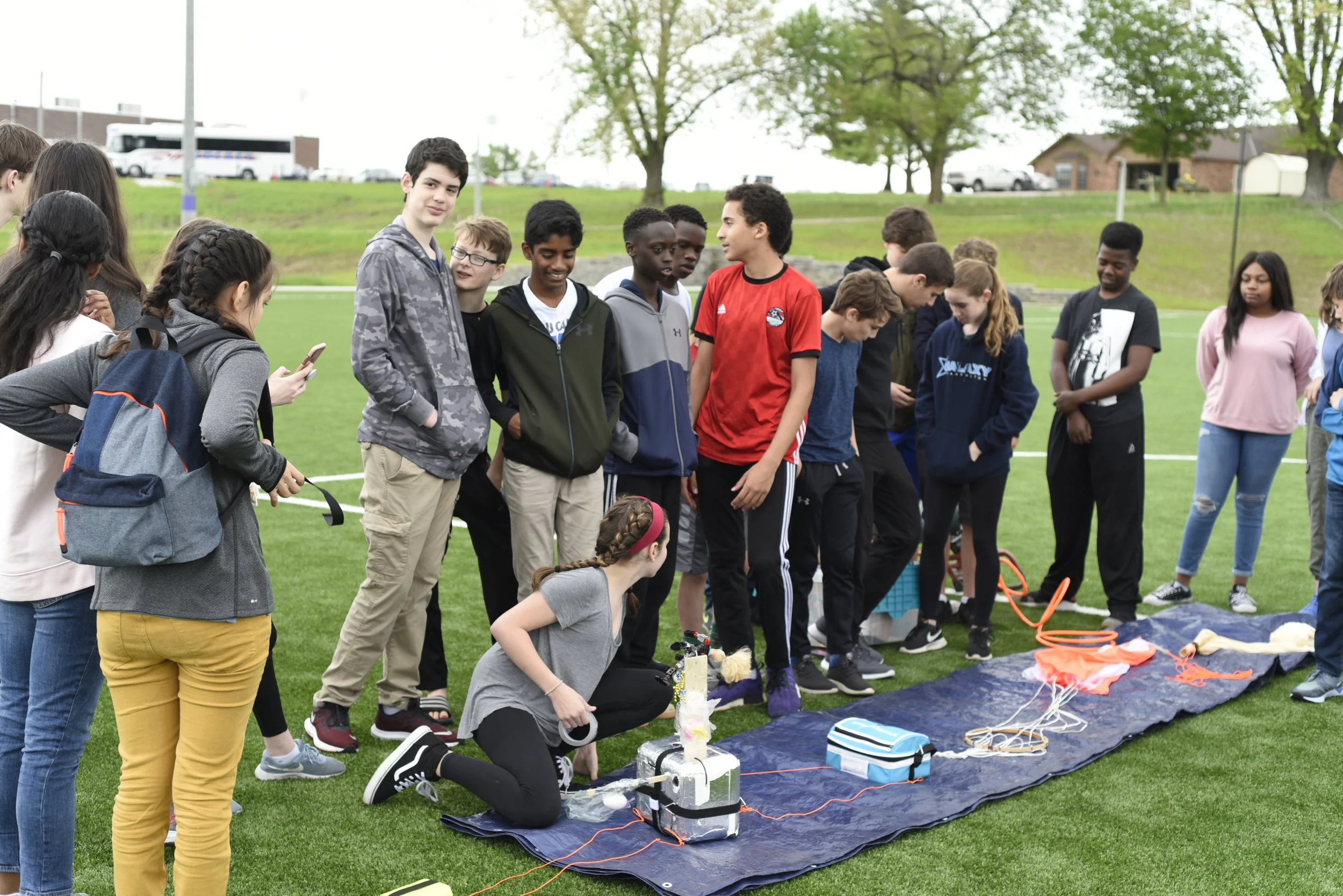 8th graders prepare the weather balloon to be filled with helium.