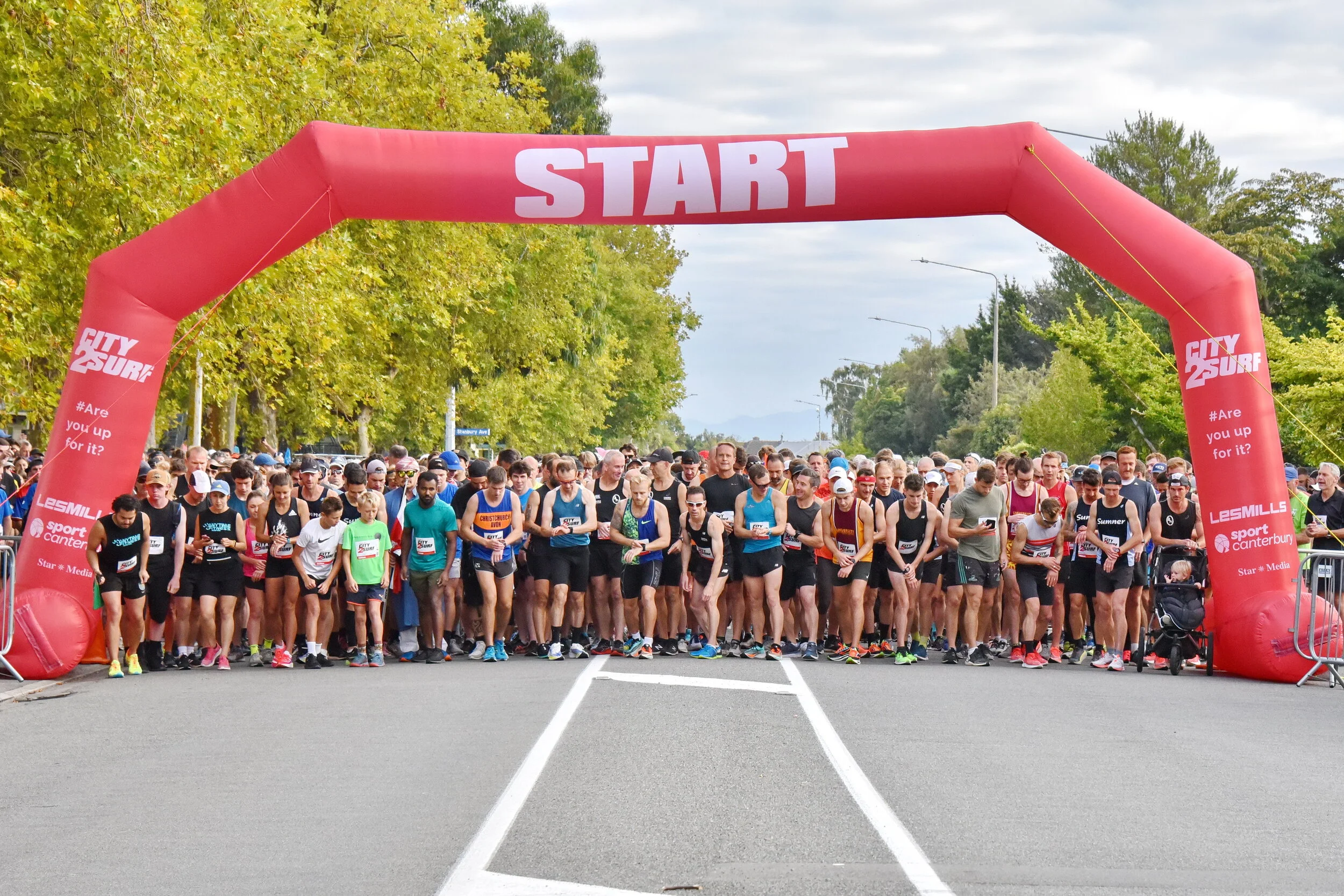 City2Surf 2021 runners waiting beneath the red start arch