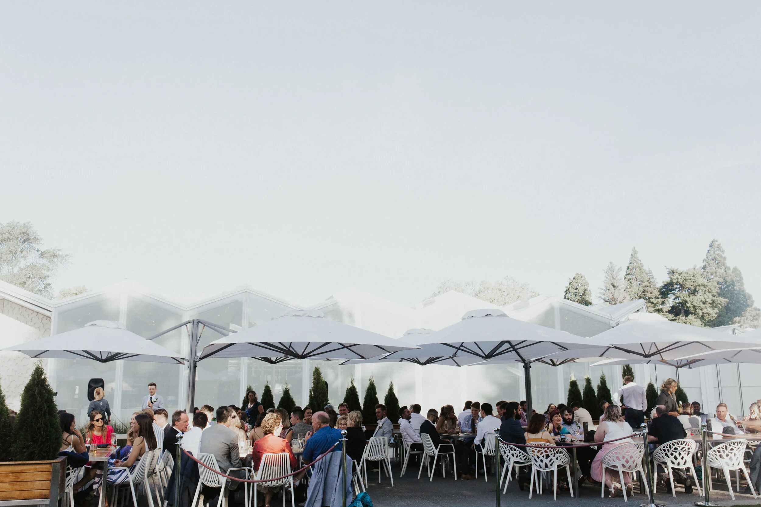 outdoor-reception-guests-white-umbrellas.jpg