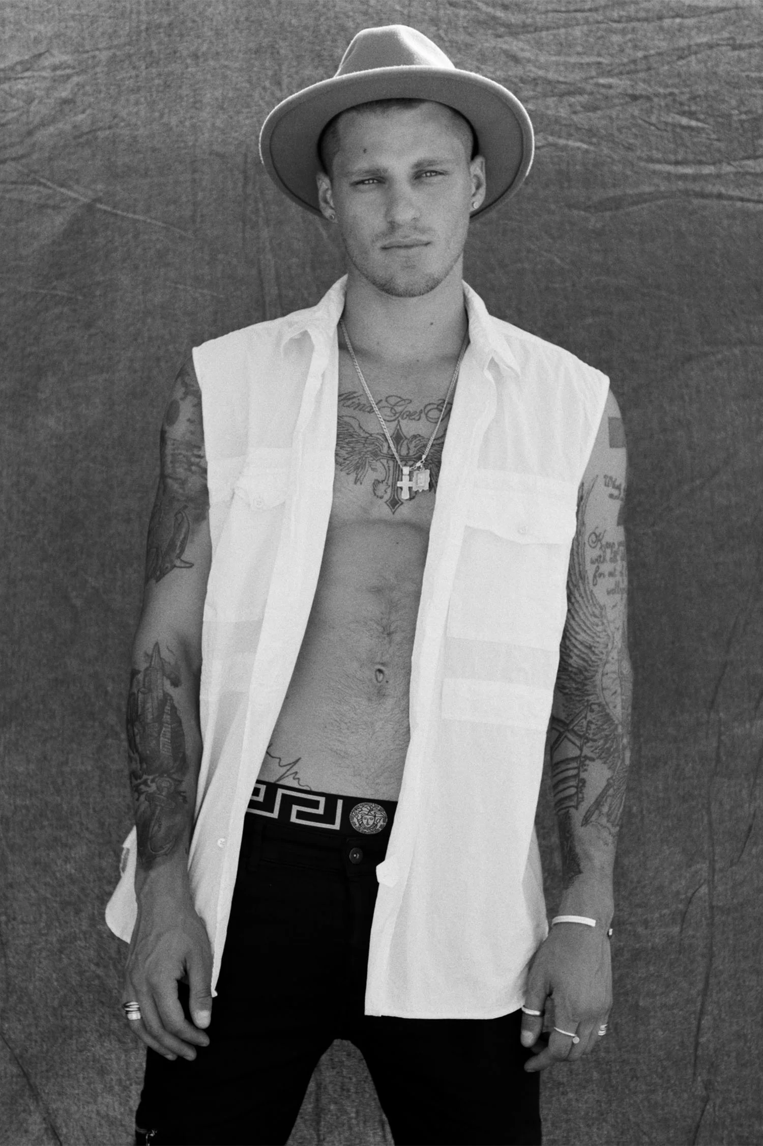 Fashion model Vadim Ivanov shows off tattoos and fit physique in open shirt for black and white photoshoot