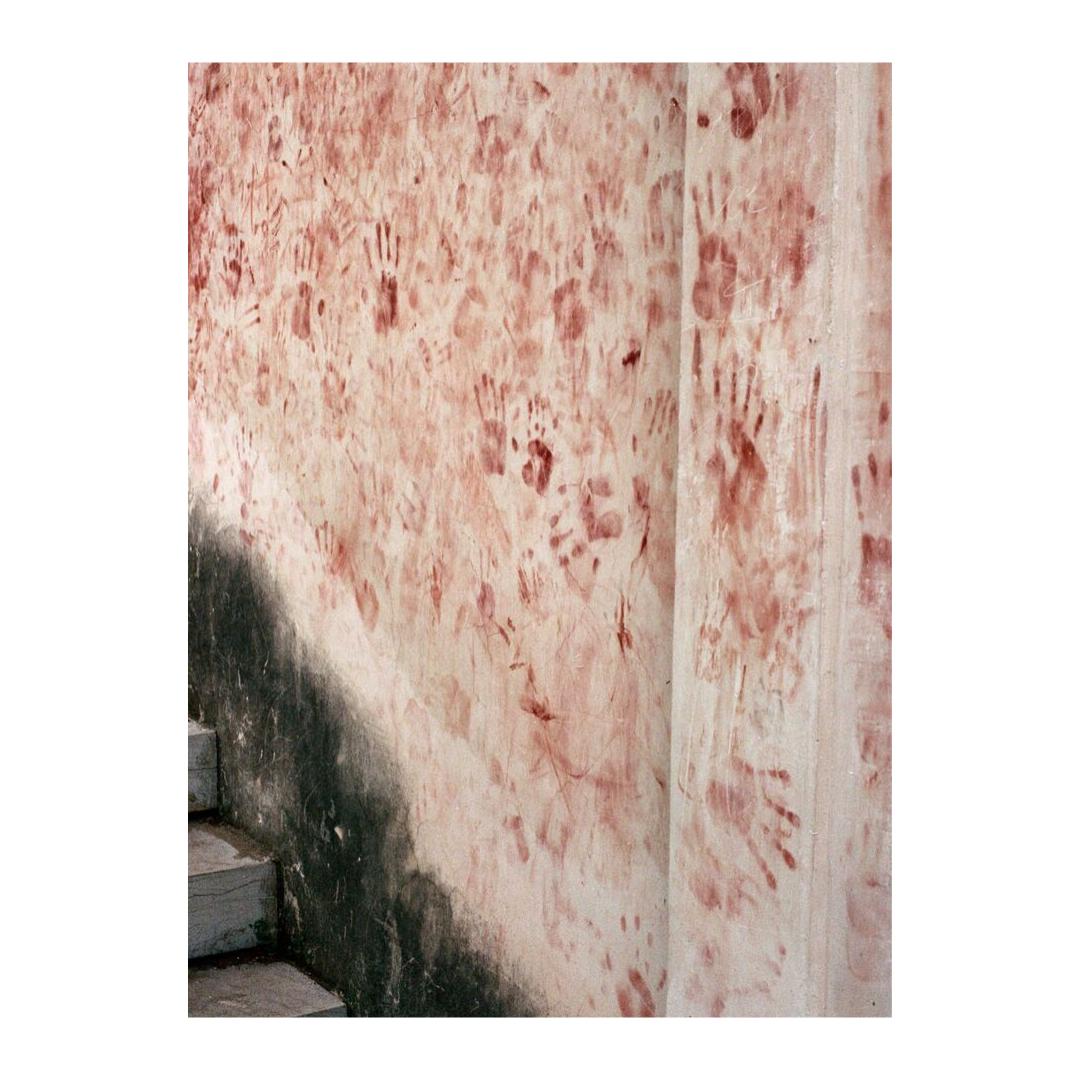 Hands of prayer haunt the walls of a temple in China. Shot on 35mm film.