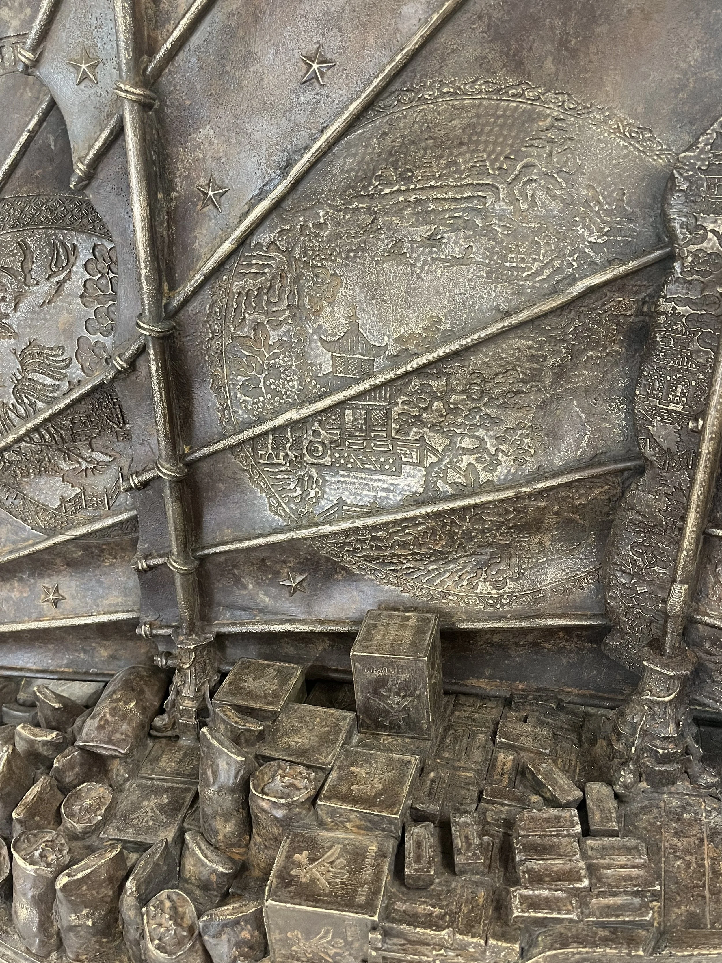 Detail of the Chinese Junk, showing 'Willow Pattern' design on sails, with tea chests, sacks of coal, bricks as cargo
