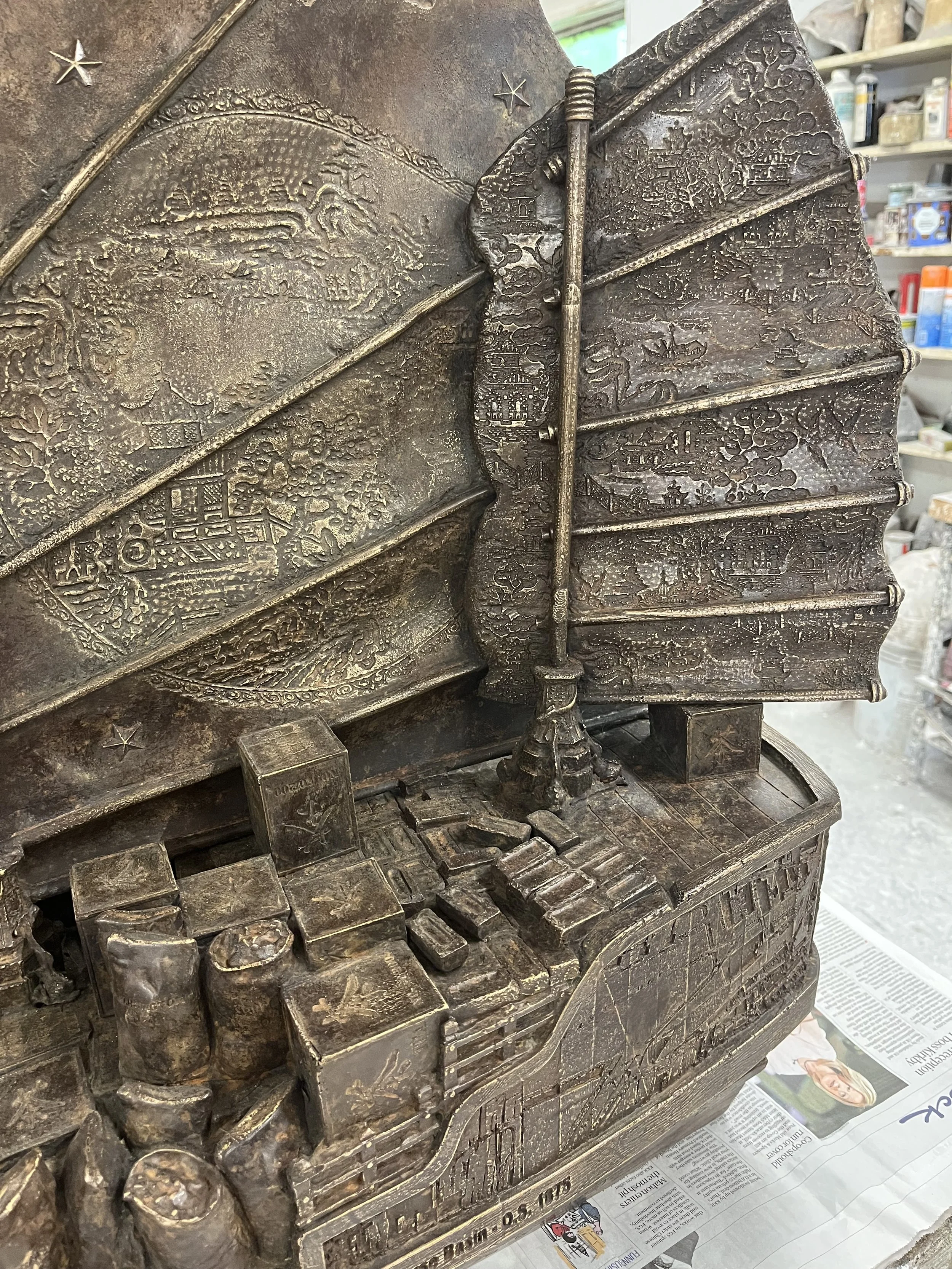 Detail of the Chinese Junk, showing 'Willow Pattern' design, flower pattern, Limehouse Basin map, tea chests, sacks of coal, bricks