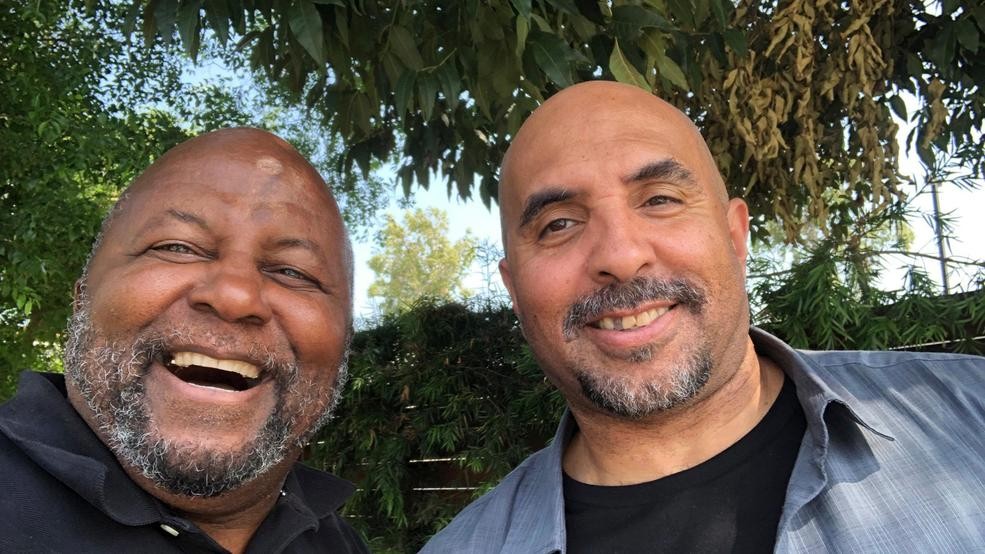 This photo provided by Mayer Brown LLP shows Kenneth Oliver, right, after his release from prison, posing for a selfie with his father Dr. Bernard Oliver on Tuesday, June 4, 2019. Kenneth Oliver, a California man, has been freed from prison after serving 23 years of his life sentence on a joyriding conviction. It included eight years in solitary confinement for possessing a book written by the co-founder of a notorious prison gang. (Bernard Oliver/Mayer Brown LLP via AP)