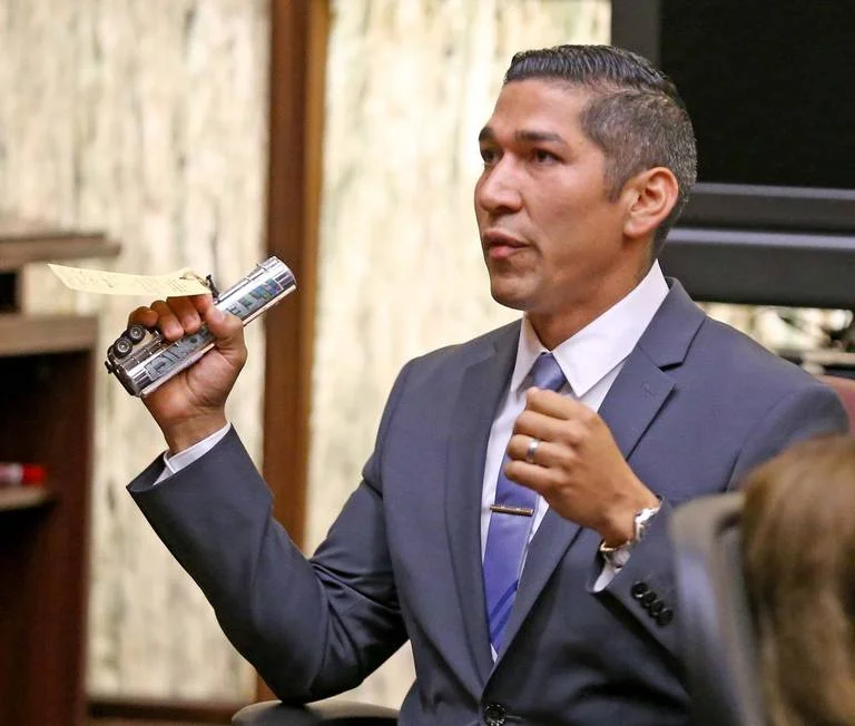 North Miami police officer Jonathon Aledda testifies with the toy mistaken for a gun at his trial over shooting at an autistic man holding the silver toy truck. The jury convicted Aledda of a misdemeanor count of culpable negligence, but acquitted him of two more serious felony counts of attempted manslaughter on Monday night, June 17, 2019. CHARLES TRAINOR JR. CTRAINOR@MIAMIHERALD.COM