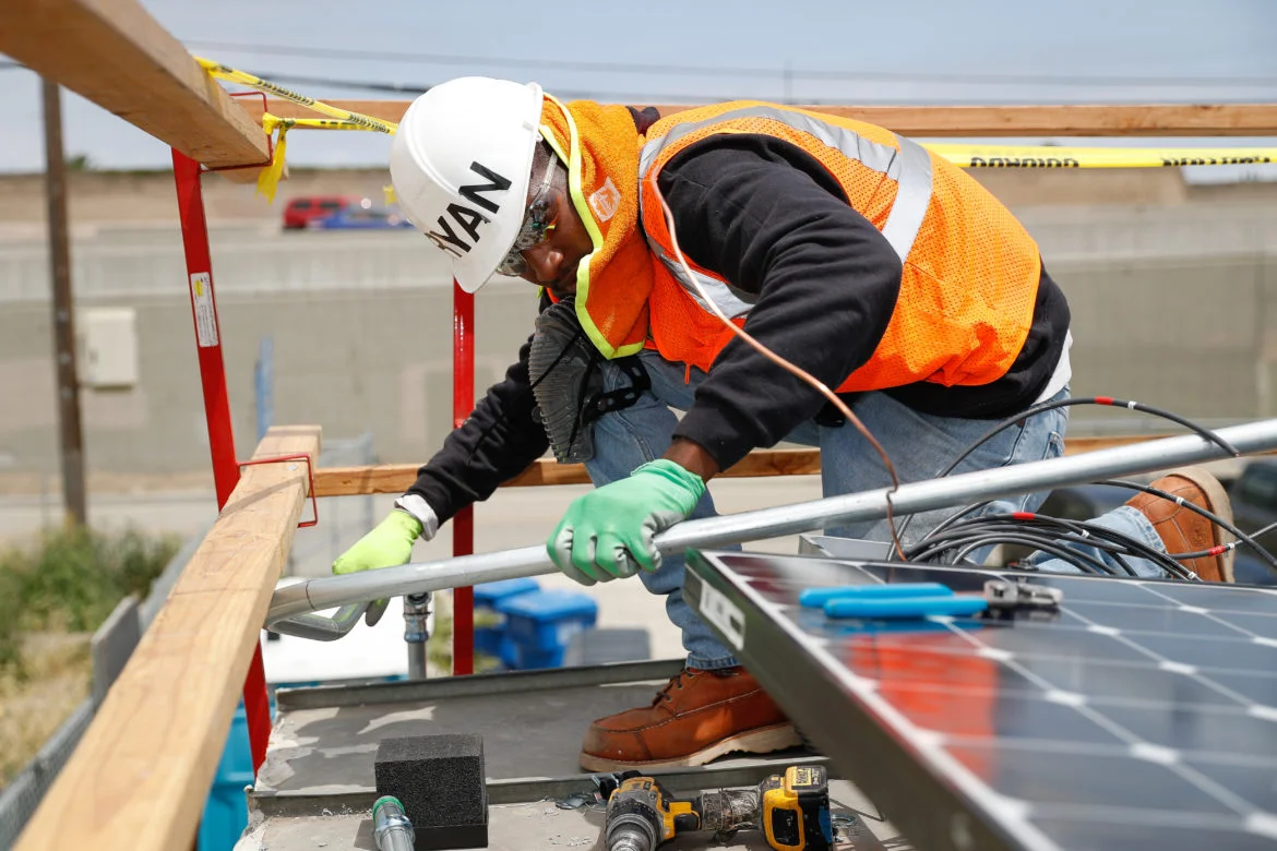Ryan Shelton of Grid Alternatives fits a pipe during a solar installation in Los Angeles, California. Shelton, 23, discovered Grid Alternatives' SolarCorps fellowship program shortly after his release from prison and is now working toward an associate degree and certificate in electrical construction and maintenance from a technical trade college in Los Angeles.