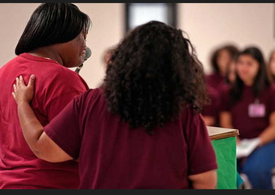 Robin Ledbetter, left, is comforted by fellow mentor Elizabeth Ruiz on Friday, June 21, 2019, as she offers her final reflection to fellow inmates and state and correctional officials during a one-year anniversary celebration of the WORTH, or Women Overcoming Recidivism Through Hard Work, unite at York Correctional Institution in Niantic. The program connects older inmates as mentors for younger inmates to help with their rehabilitation and reintegration. (Sean D. Elliot/The Day)