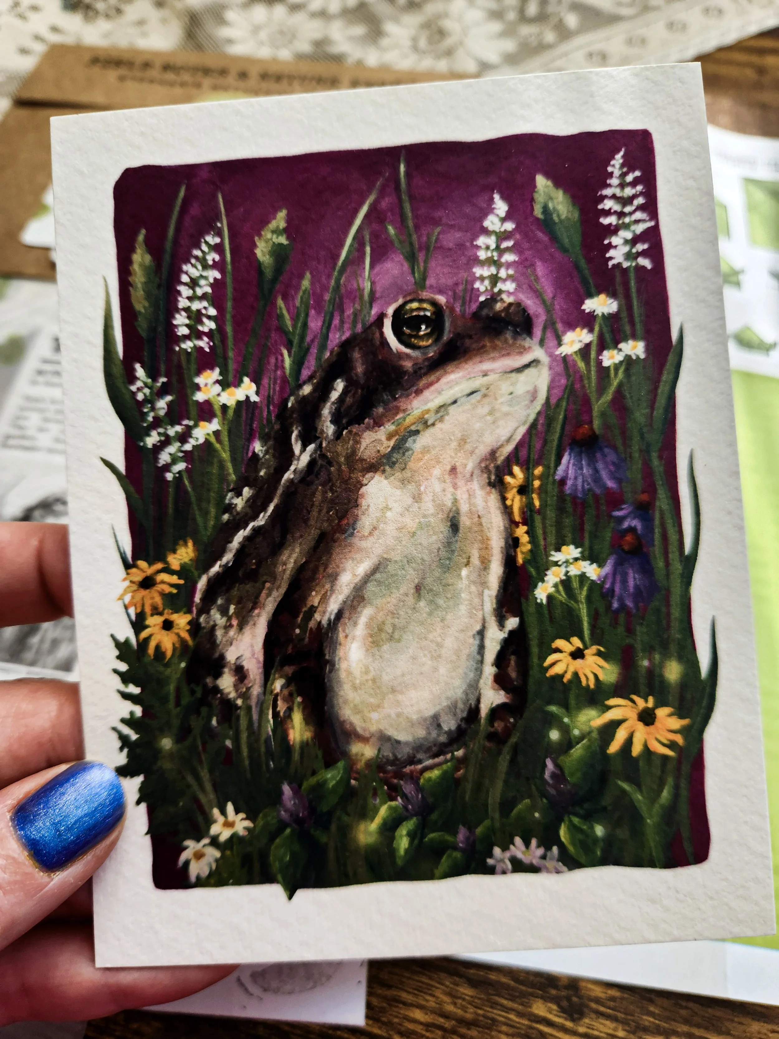 Close-up of illustrated toad art print included in the mail club