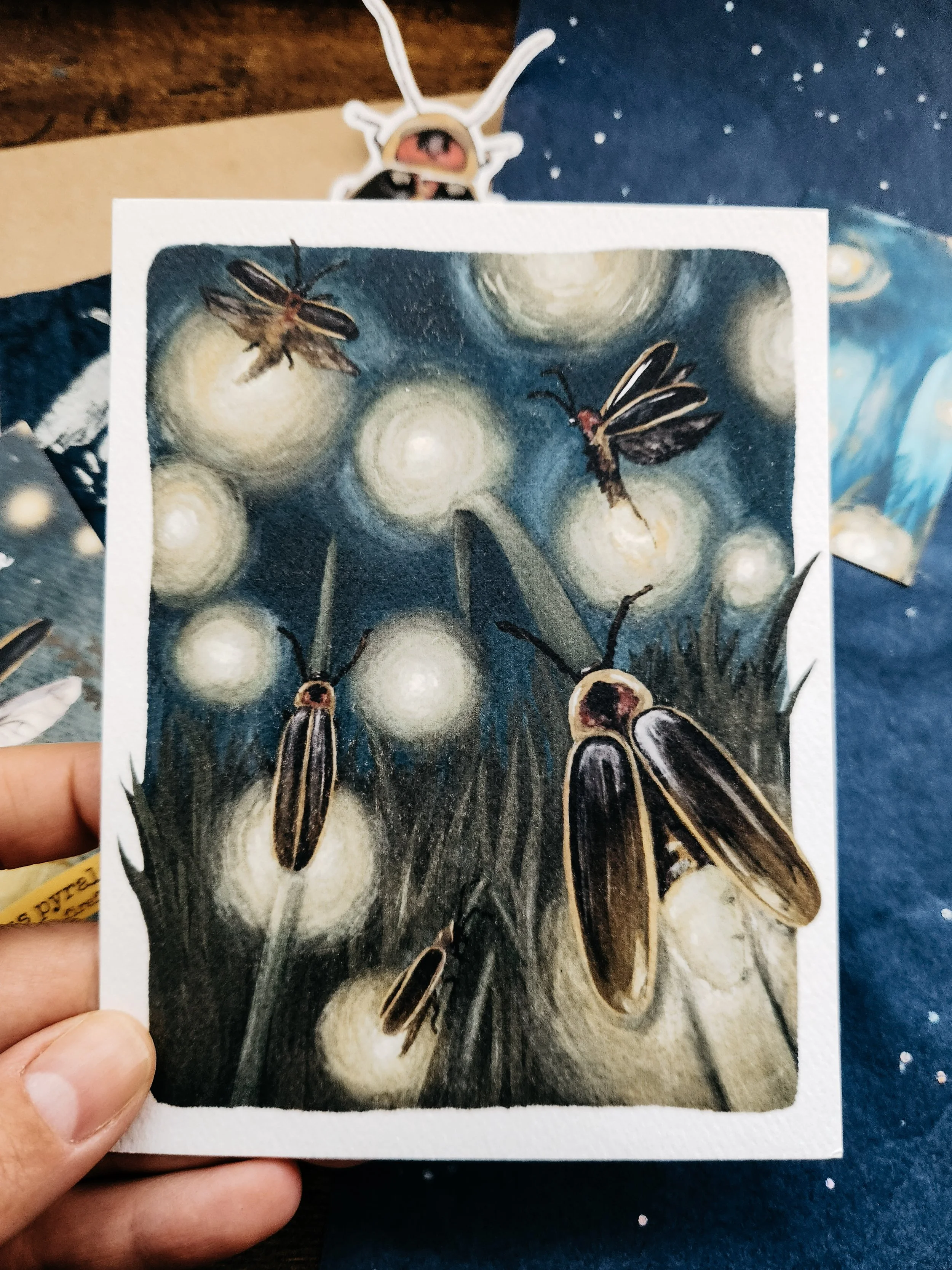 Illustrated firefly art print designed as a postcard, printed on textured archival paper.