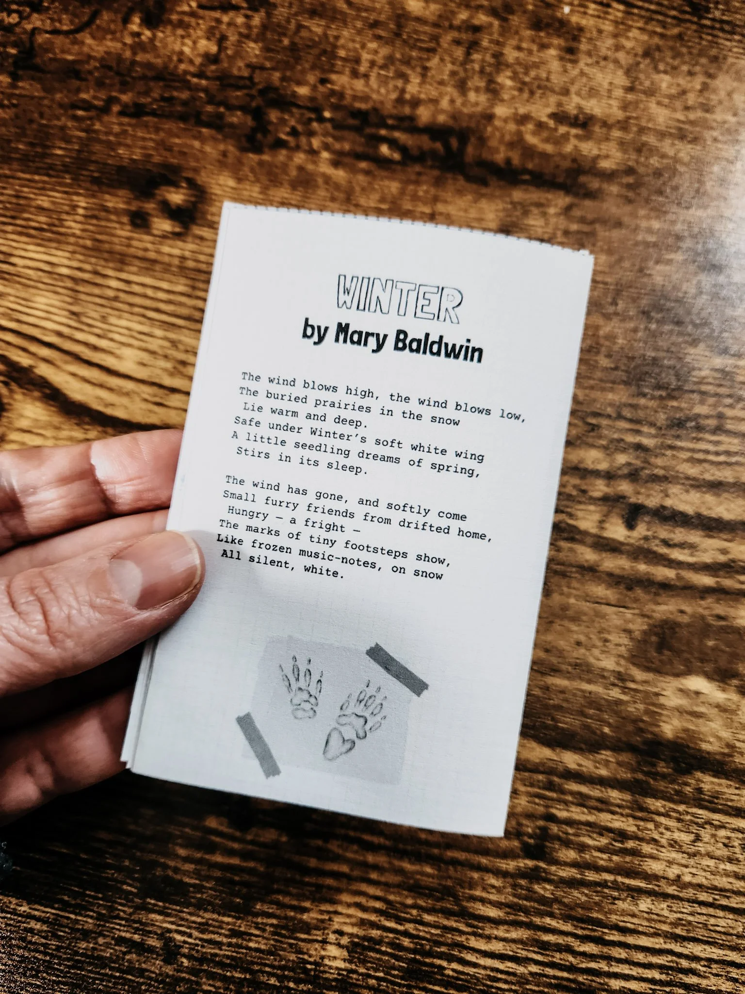 Inside page of the groundhog mini zine featuring a short public domain poem about winter and a small groundhog illustration at the bottom.