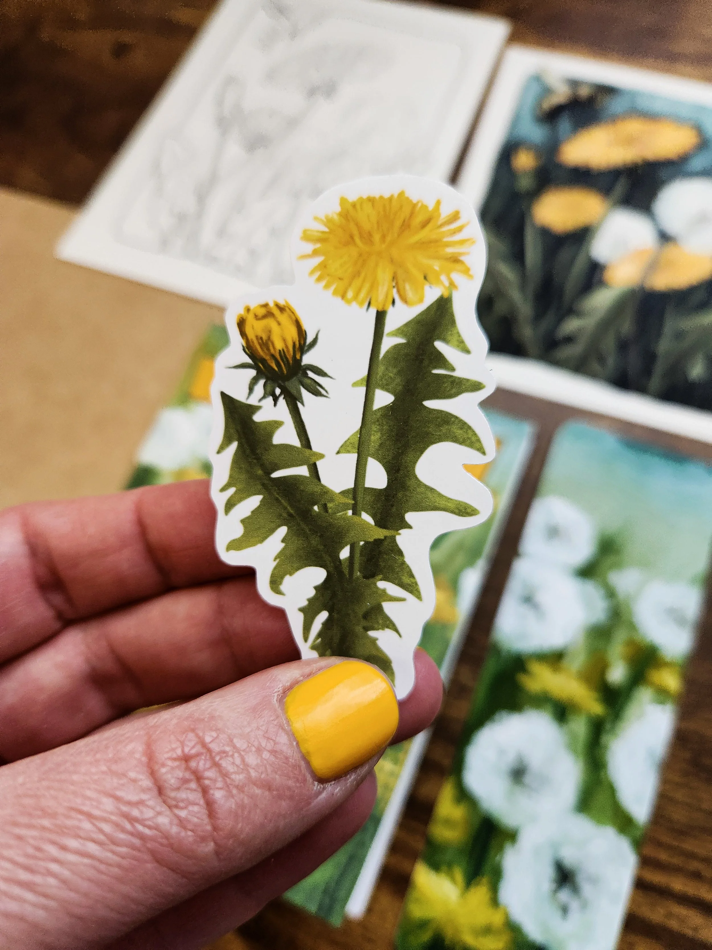 Close-up of dandelion vinyl sticker with yellow flower illustration on a white background.