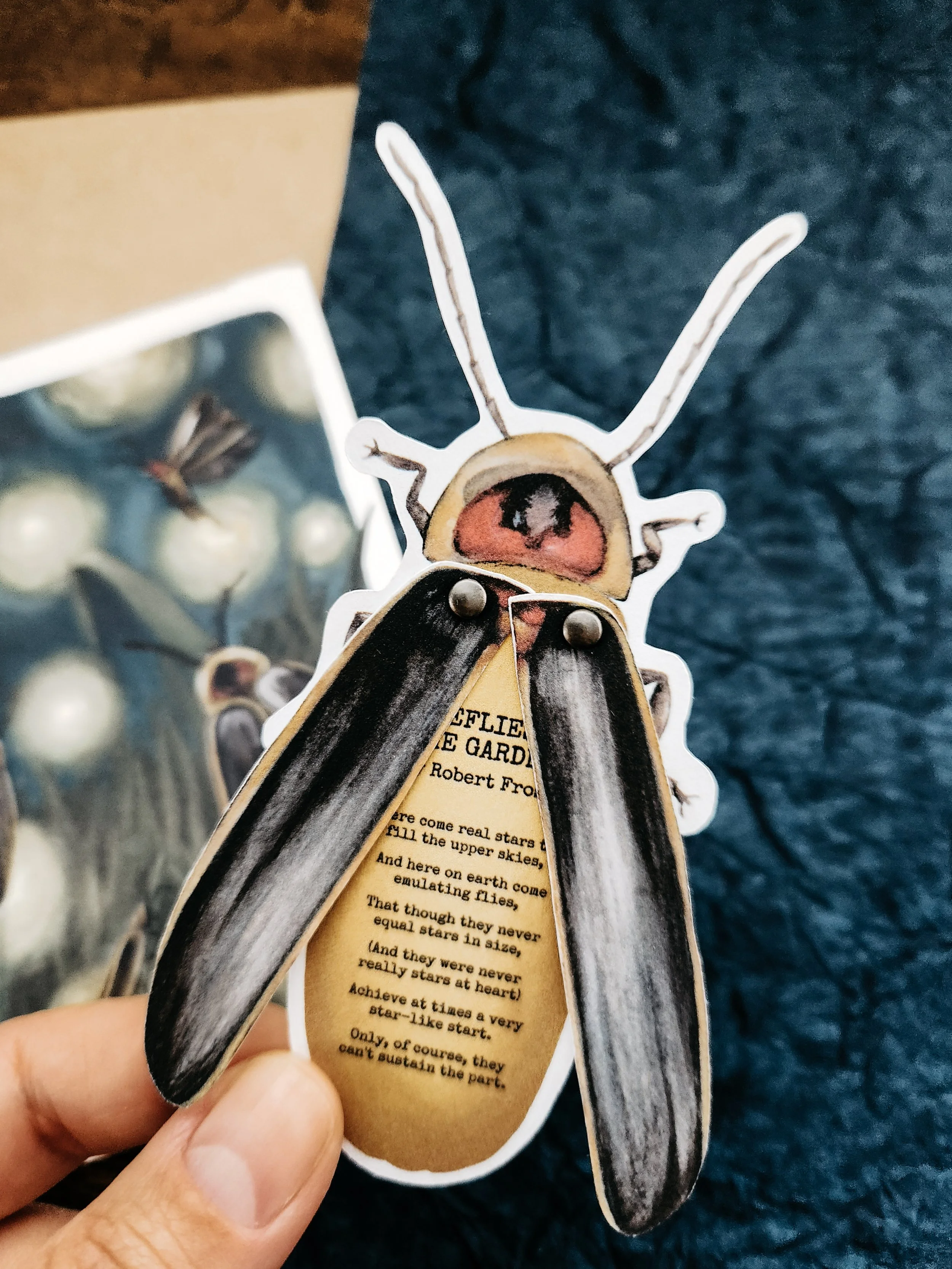 Paper firefly with moveable wings displayed alongside a public domain poem.