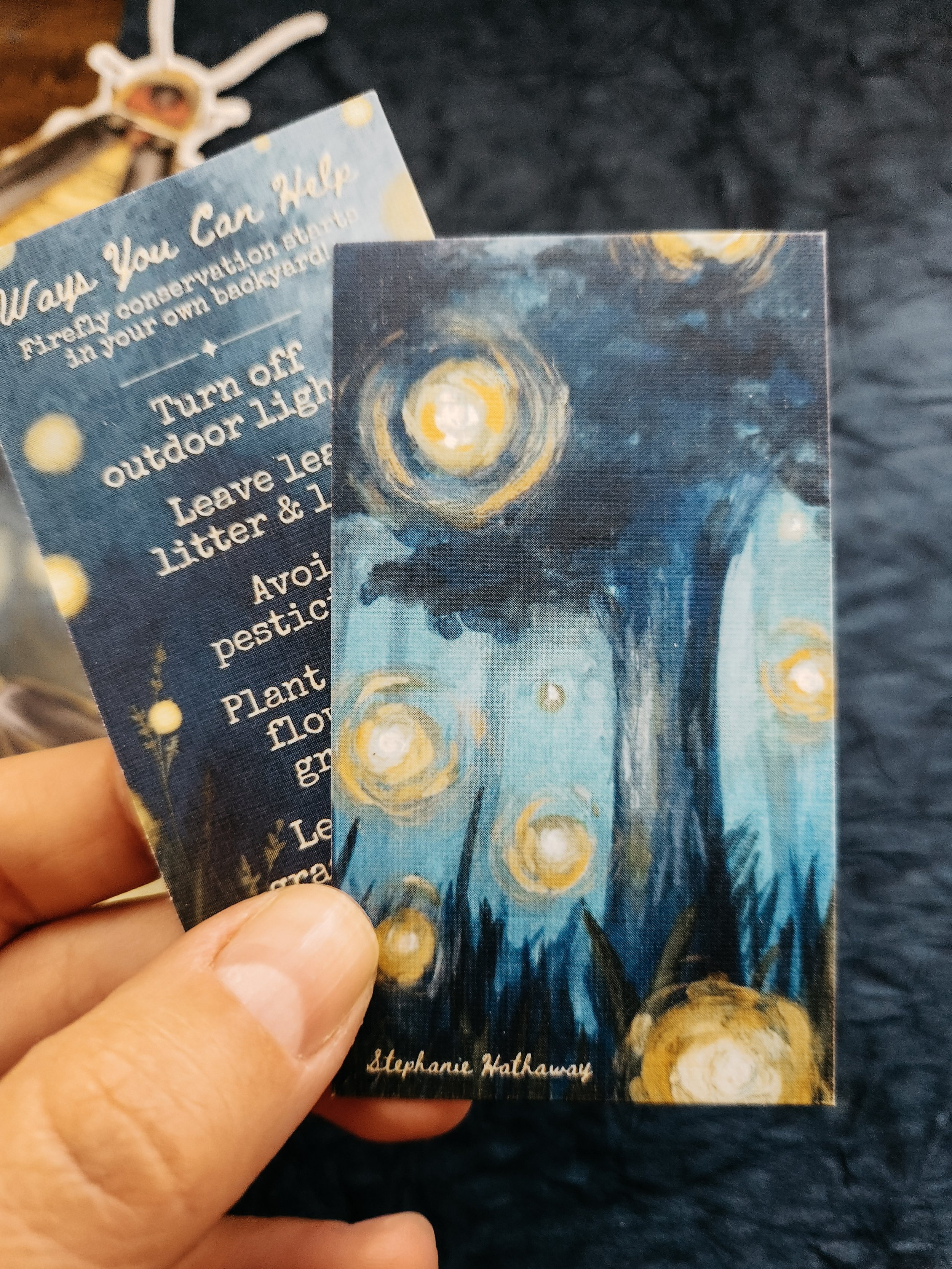 Front and back of the firefly mini art print featuring an illustrated design on one side and firefly conservation tips on the other.