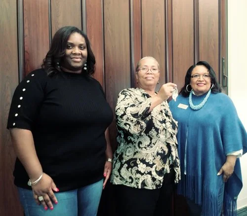 Kanica James, left, came to her mother’s house closing. On right is Homeport Lease-Option Program Manager Brenda Moncrief.