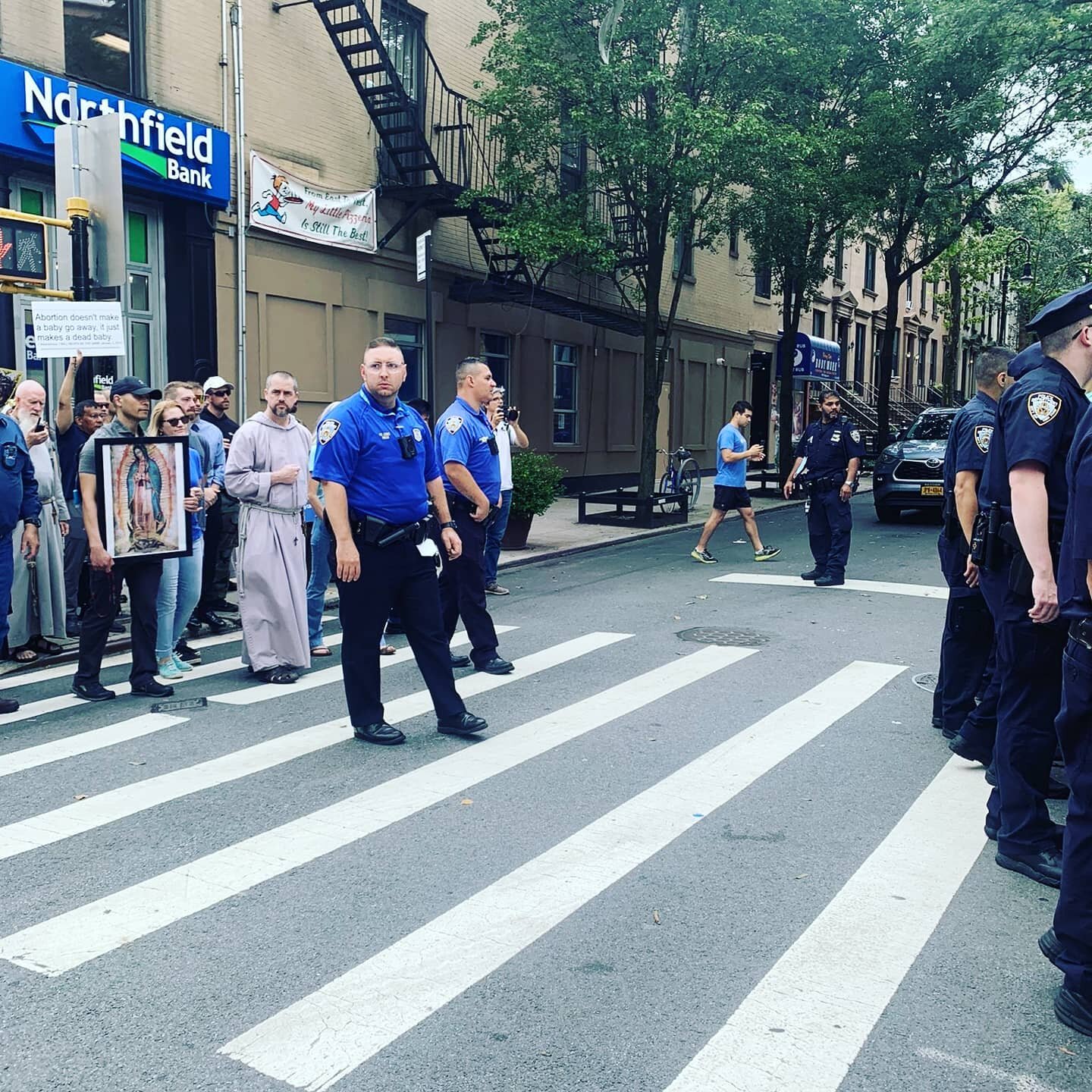 Catholics had to be protected by NYPD today as they marched from St. Paul's Church in New York to a local abortuary. 

Anti baby activists protested with signs such as 'abortion is freedom' and 'God loves abortion', screaming obscenities as Mass took