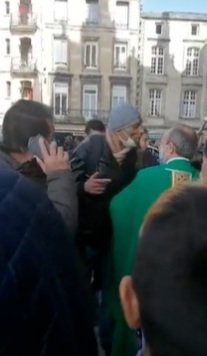 Muslims SPITS in French Priest's FACE