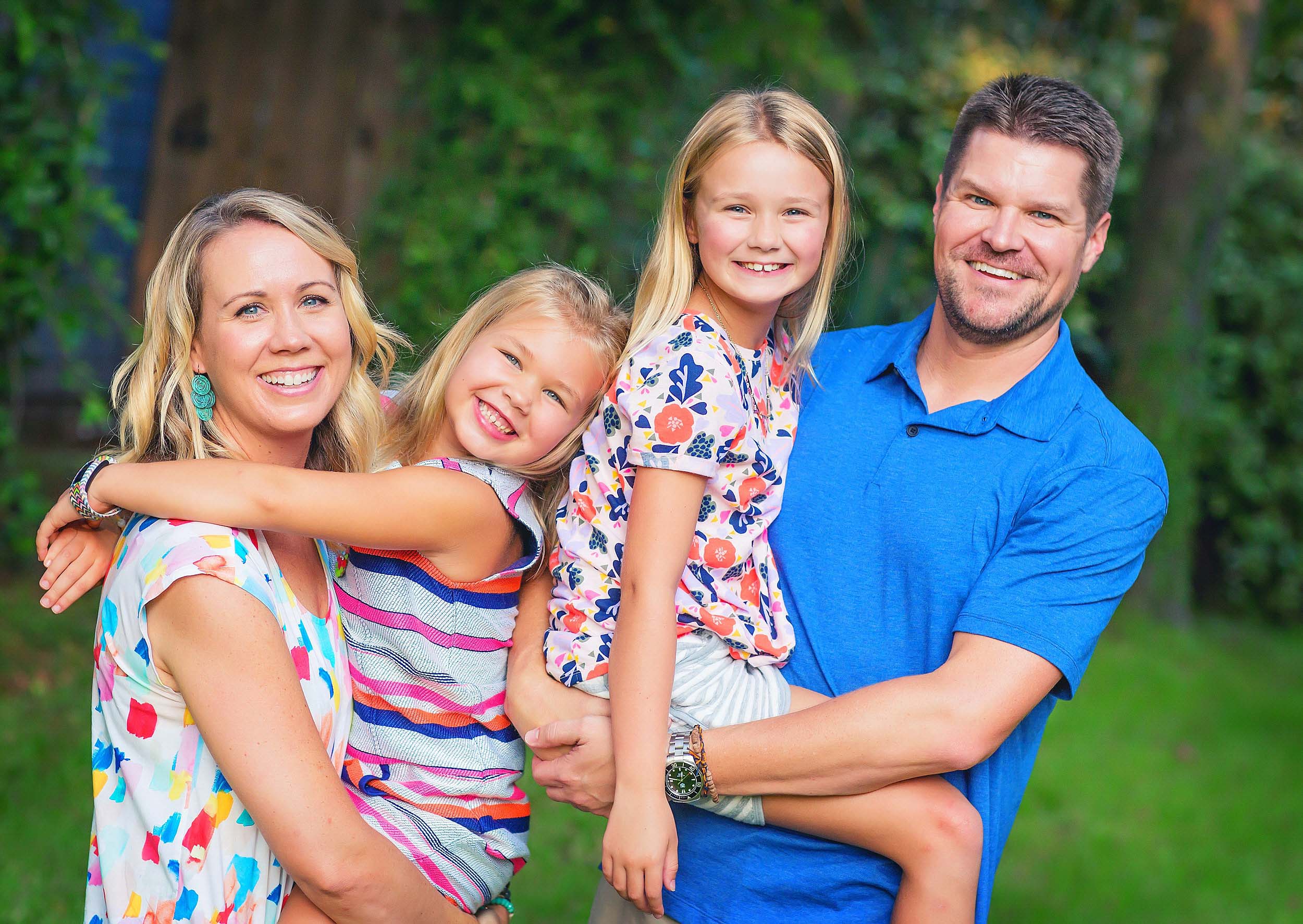  Family portrait in colorful and vibrant clothing by family photographer spryART photography in The Woodlands, Texas. 