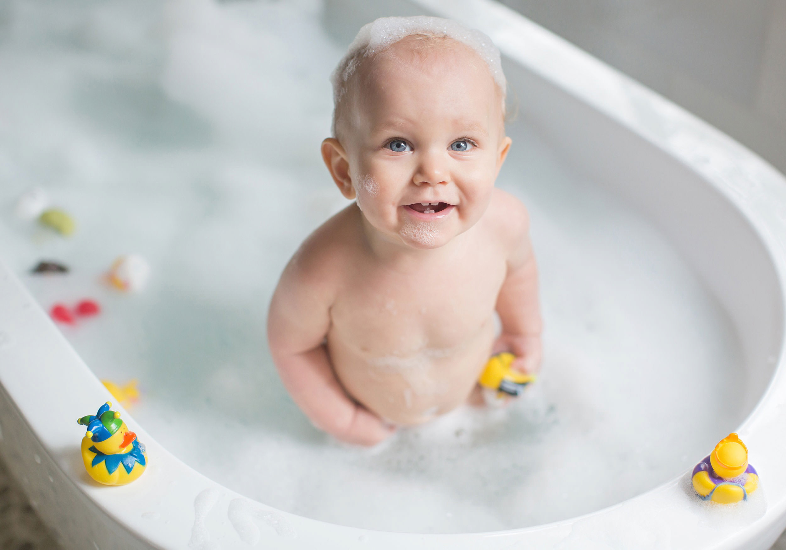  One year portrait of baby boy in bathtub by spryART photography. 
