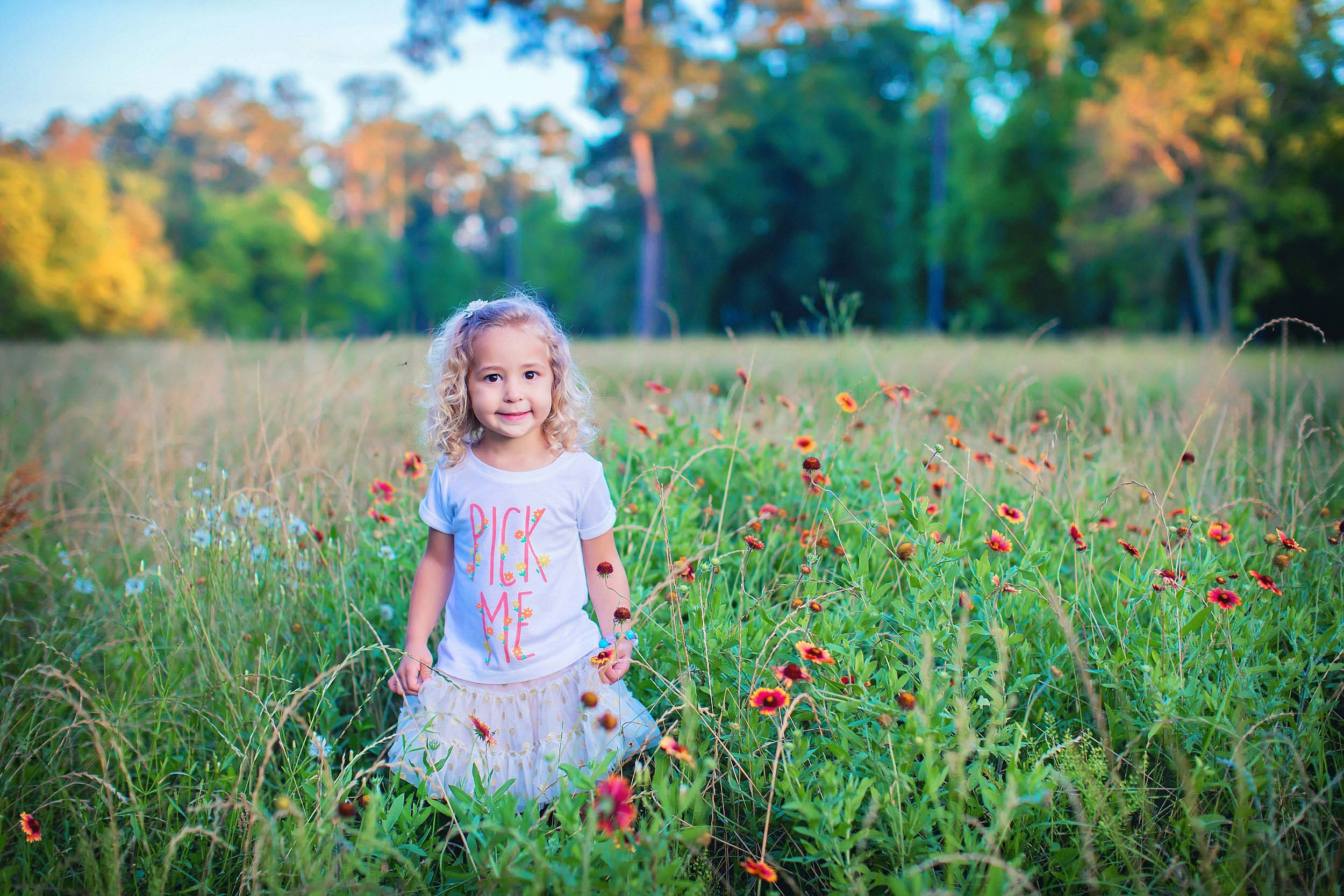  Portrait of lIttle girl standing in wildflowers in The Woodlands, Texas 