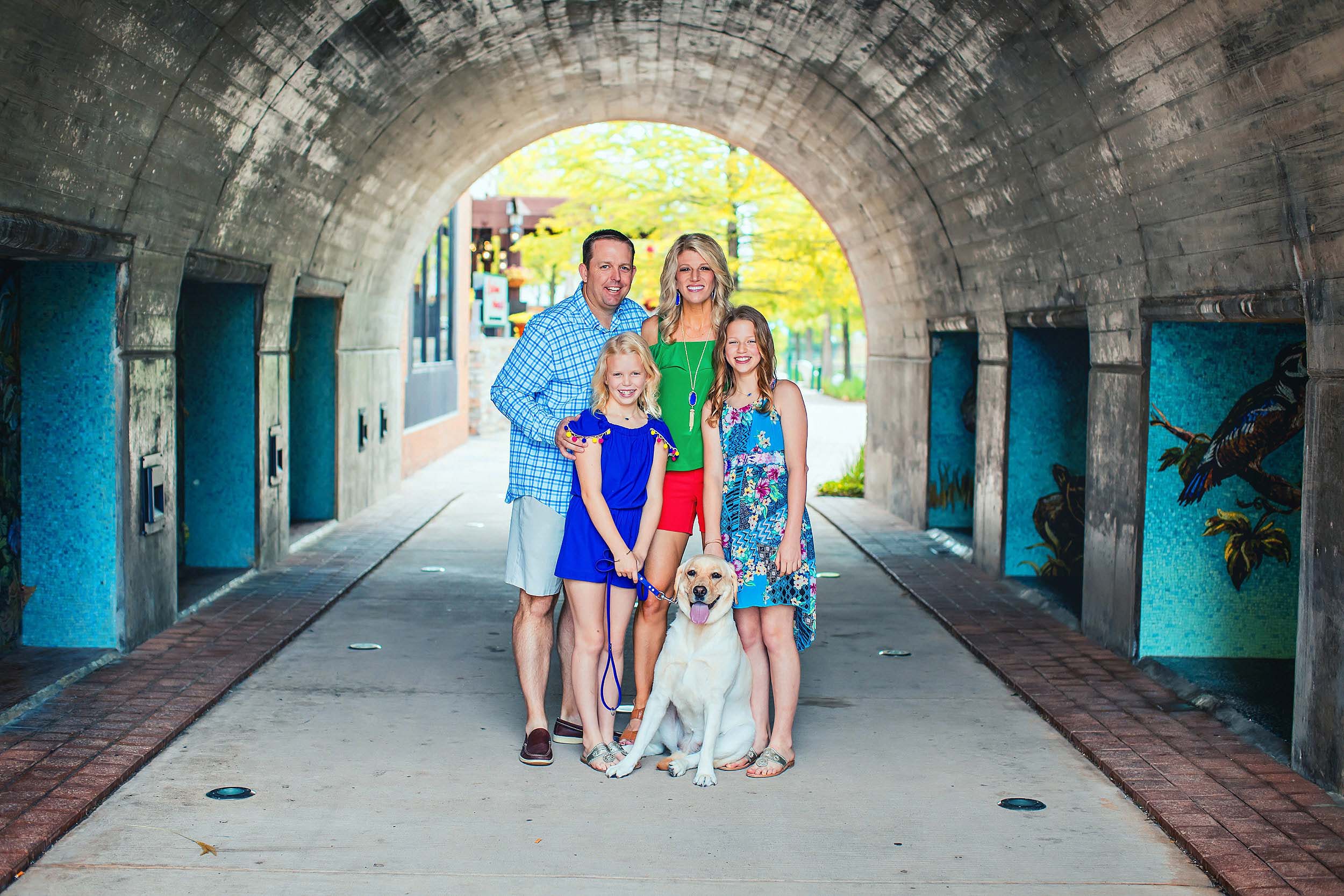  Portrait of family and pet dog in colorful clothes in The Woodlands Texas. 