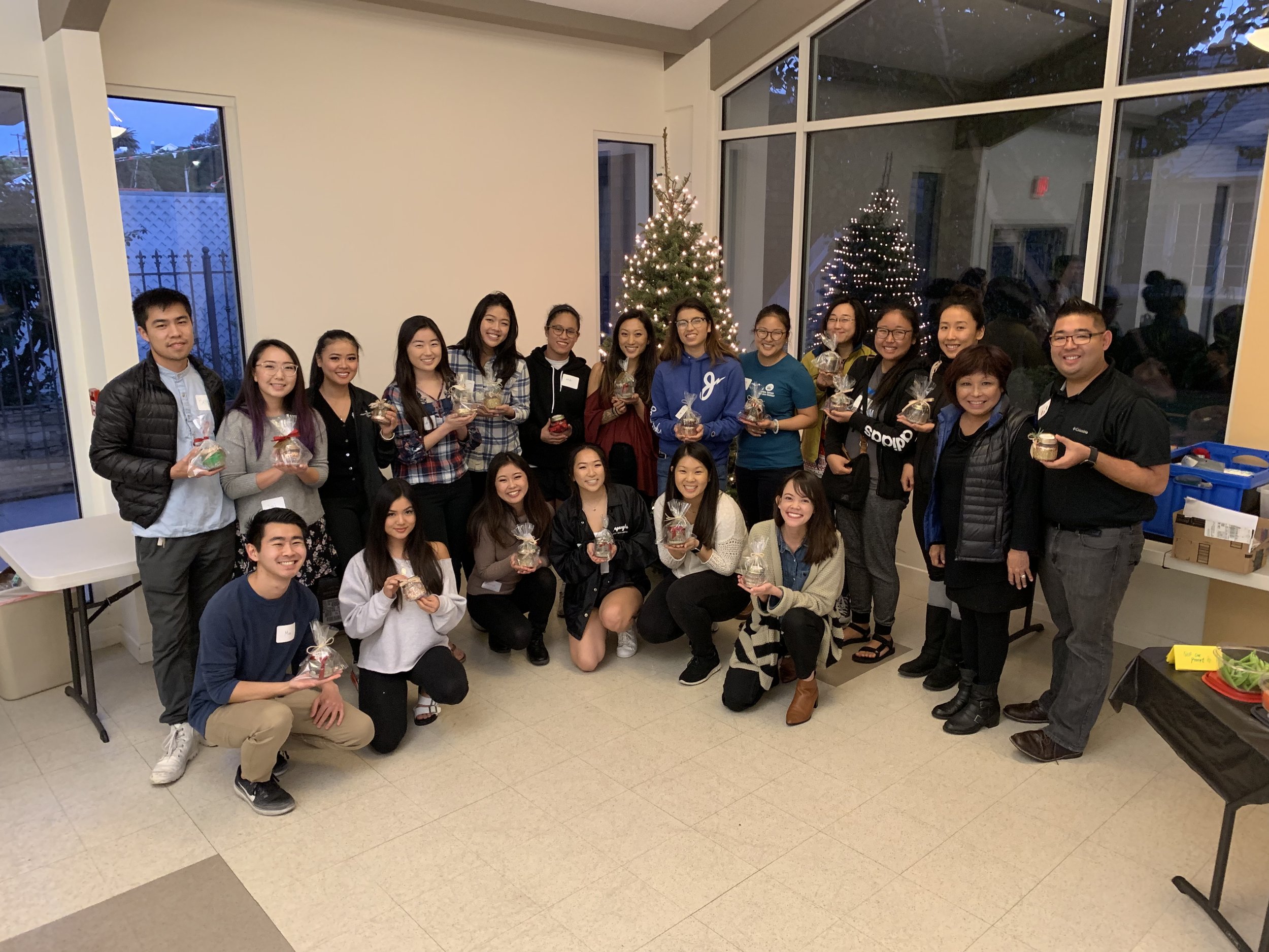 A group poses showing off the candles they have made.