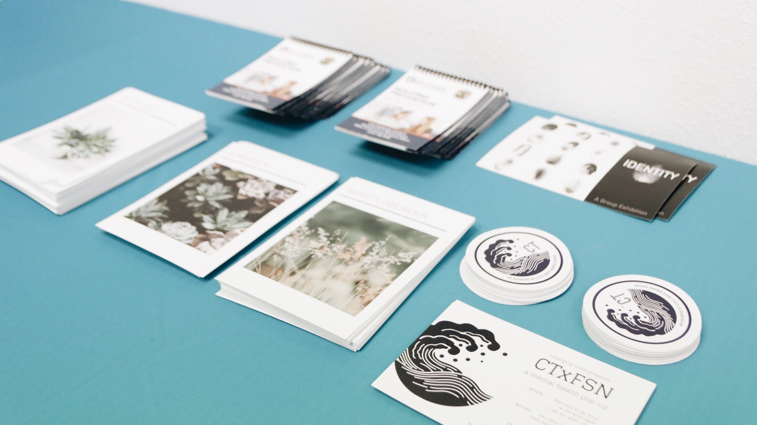Promo cards are seen placed on a table. 