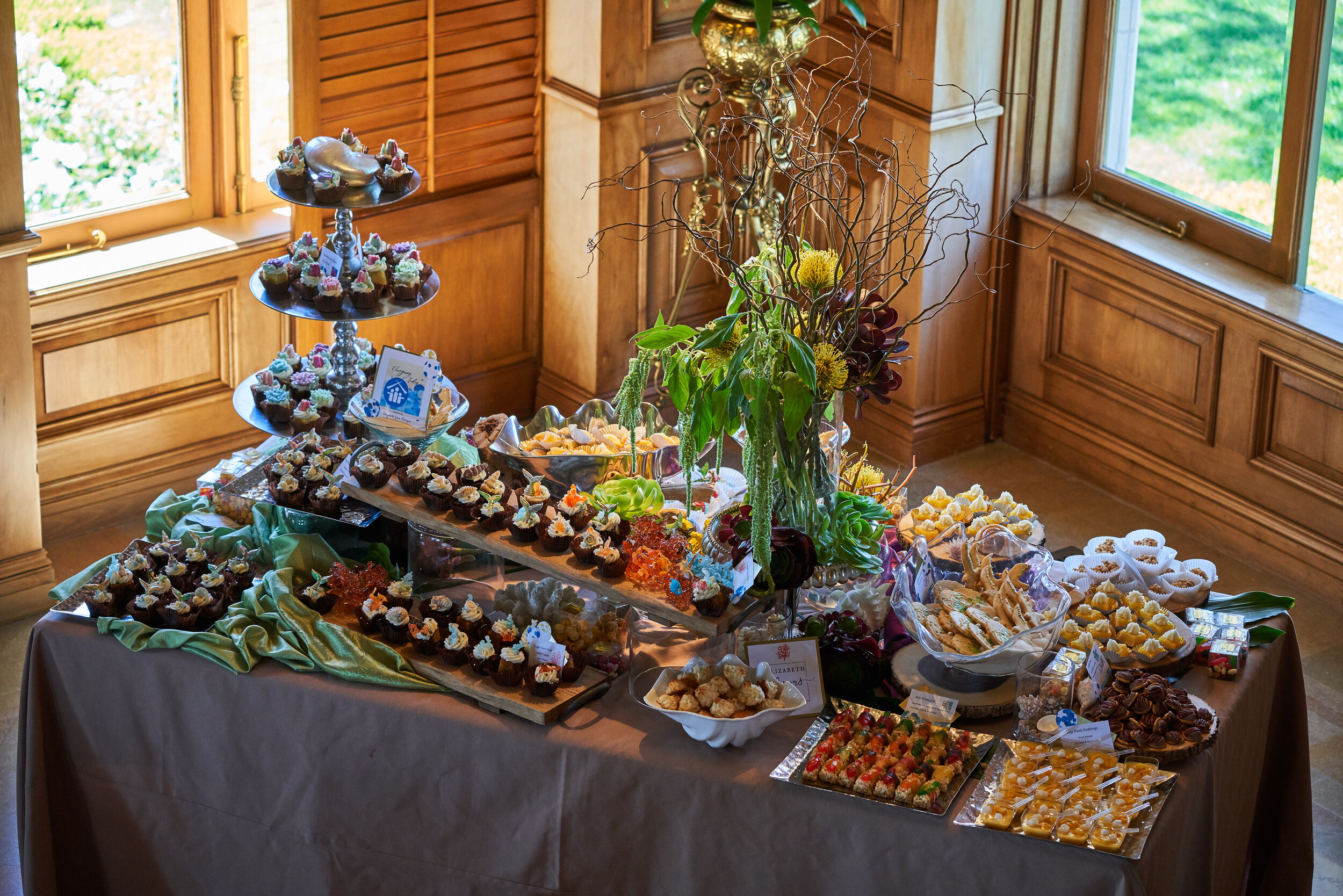 A variety of desserts are displayed on a table.