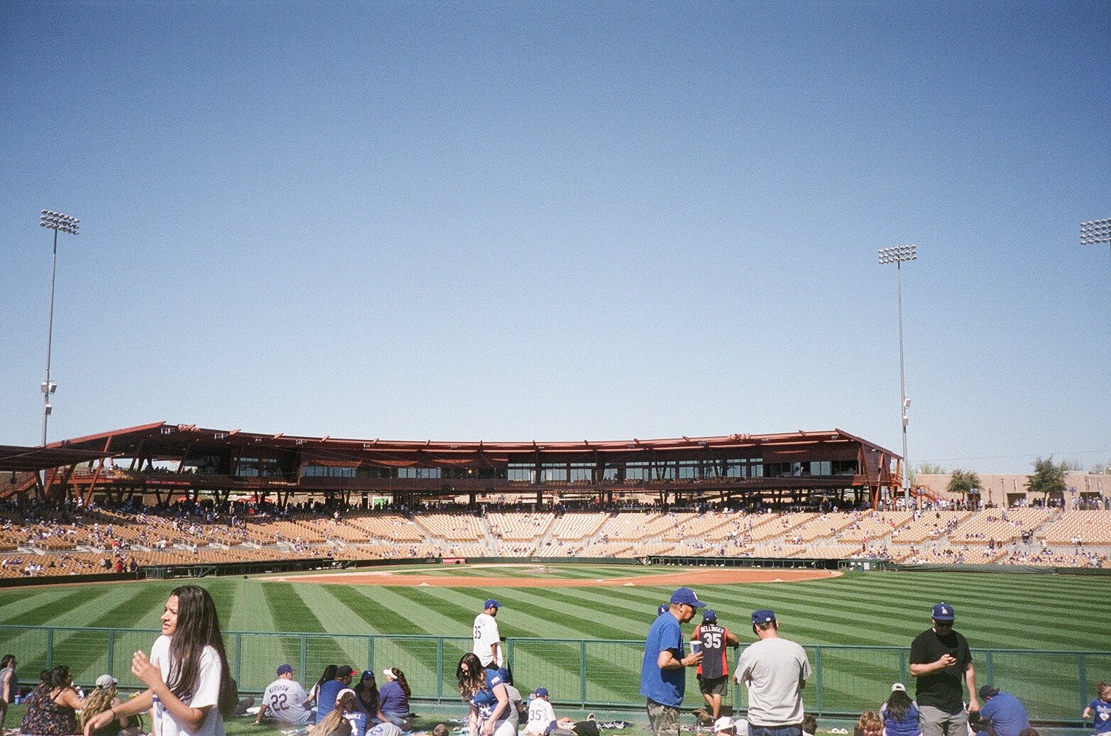 A baseball field is seen with fans in the stands.