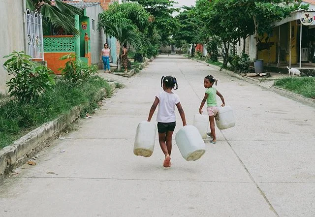 2 girls do after school errands on one of the main streets of La Ciudad de Las Mujeres.
