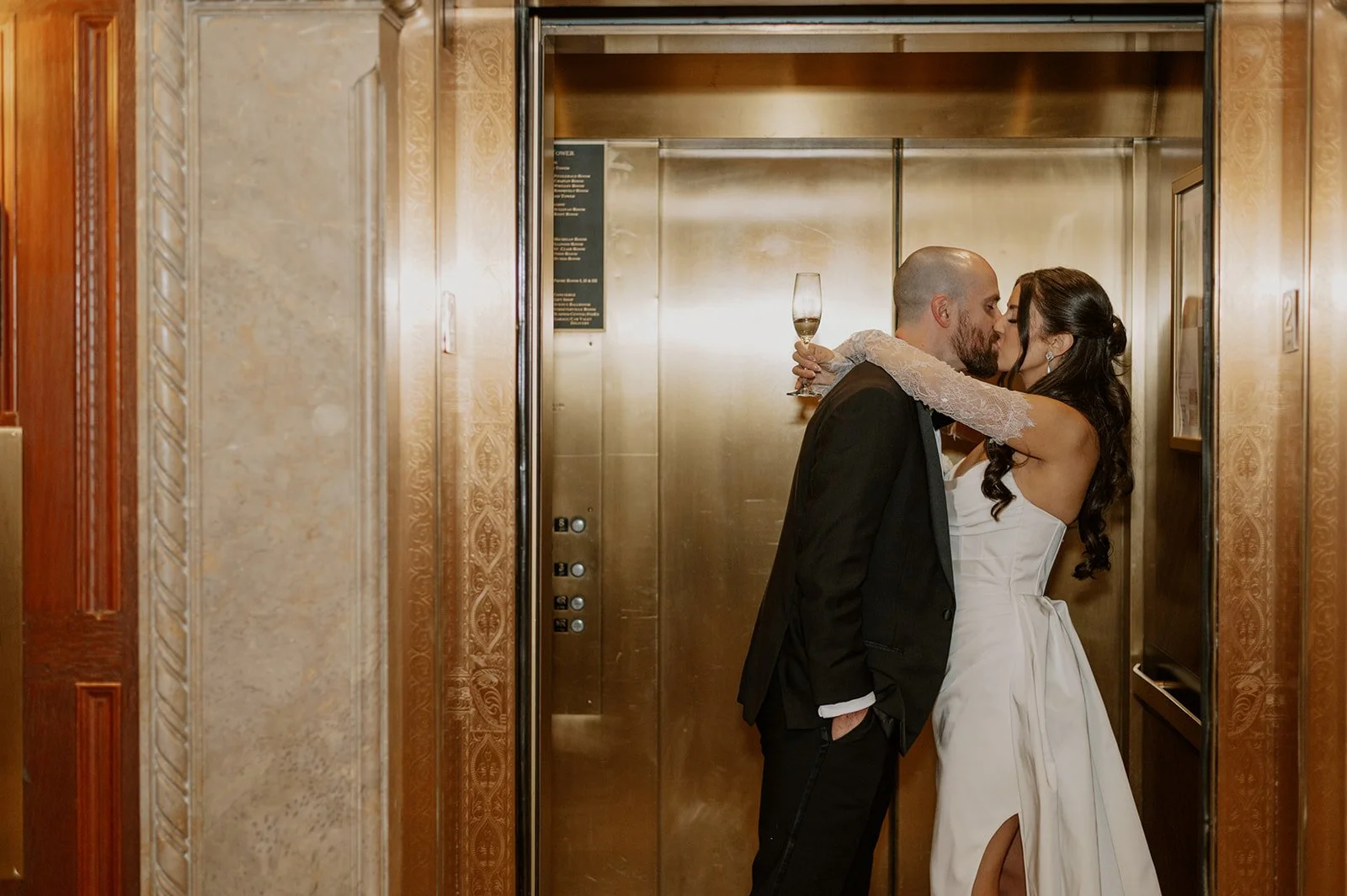 Newlyweds share a kiss in the elevator following their Intercontinental Chicago wedding.