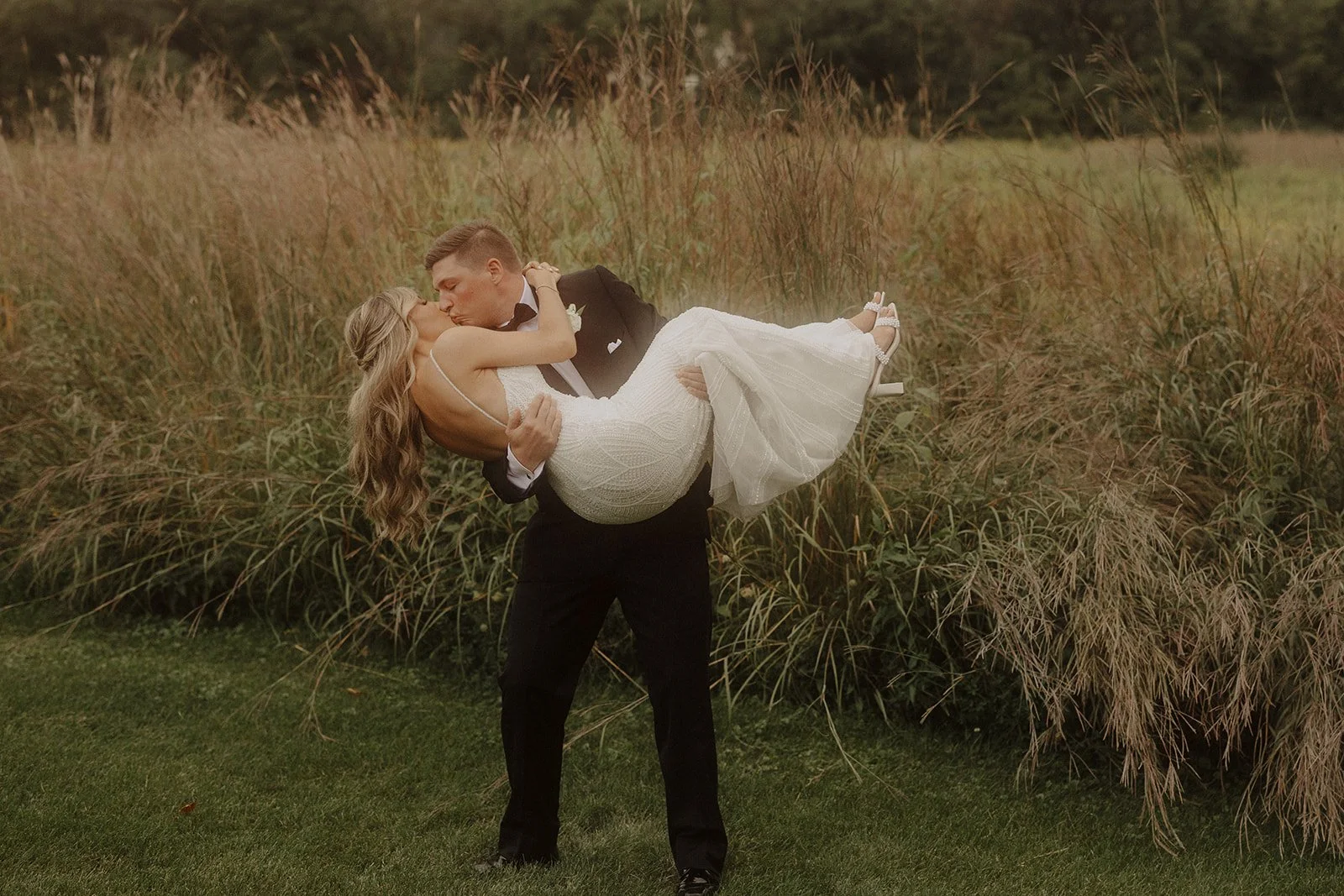 A bridal portrait of two newlyweds sharing a kiss at their Monte Bello Estate wedding