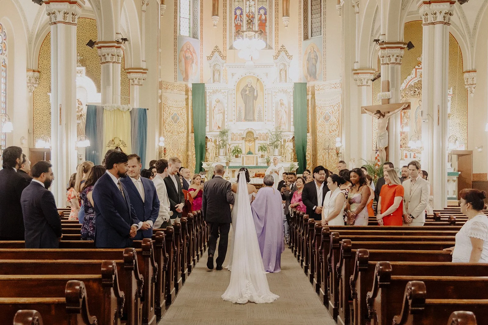 A bride is walked down the aisle of a church for her Chicago wedding.