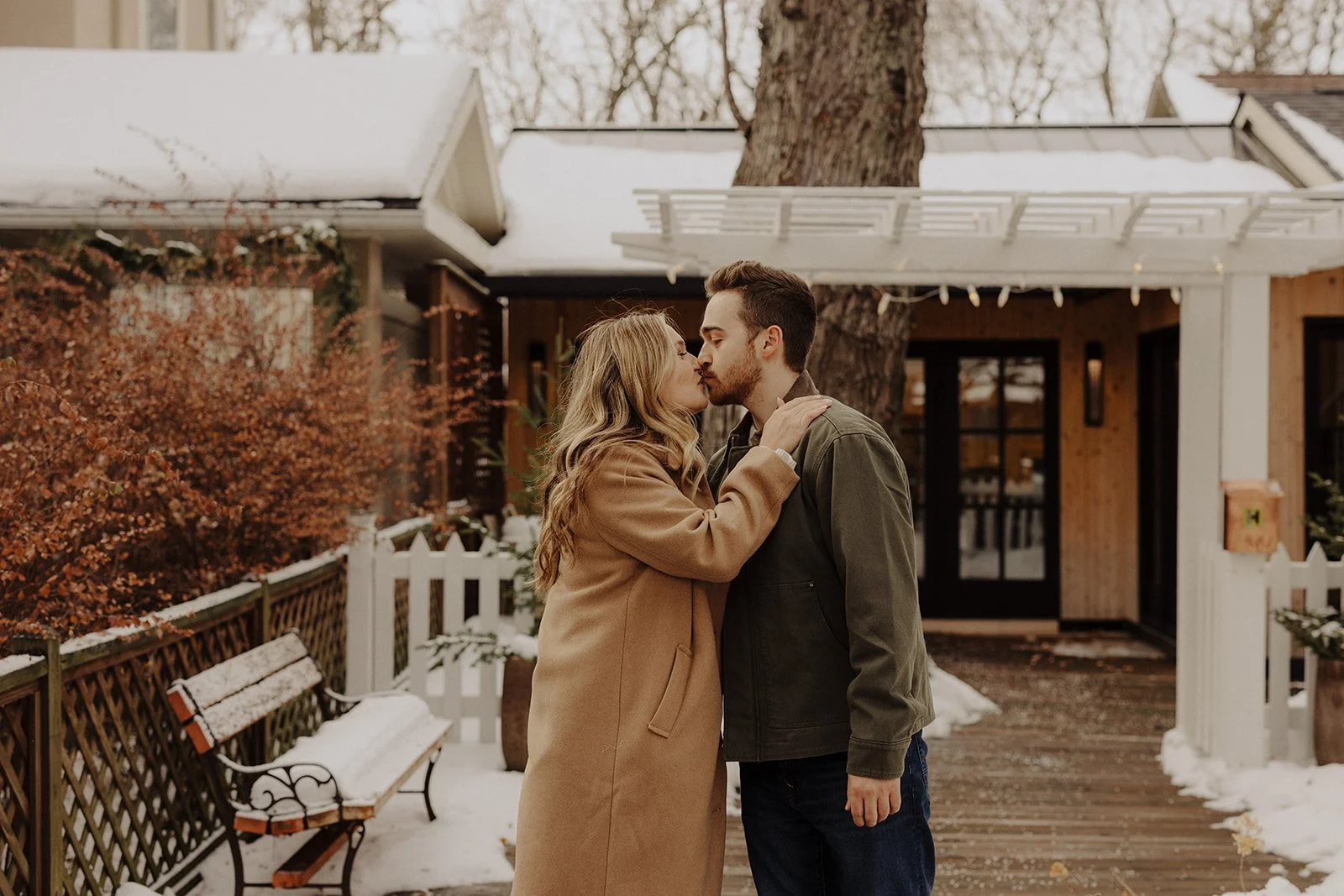 A young IL couple share a kiss during engagement photography in Geneva IL
