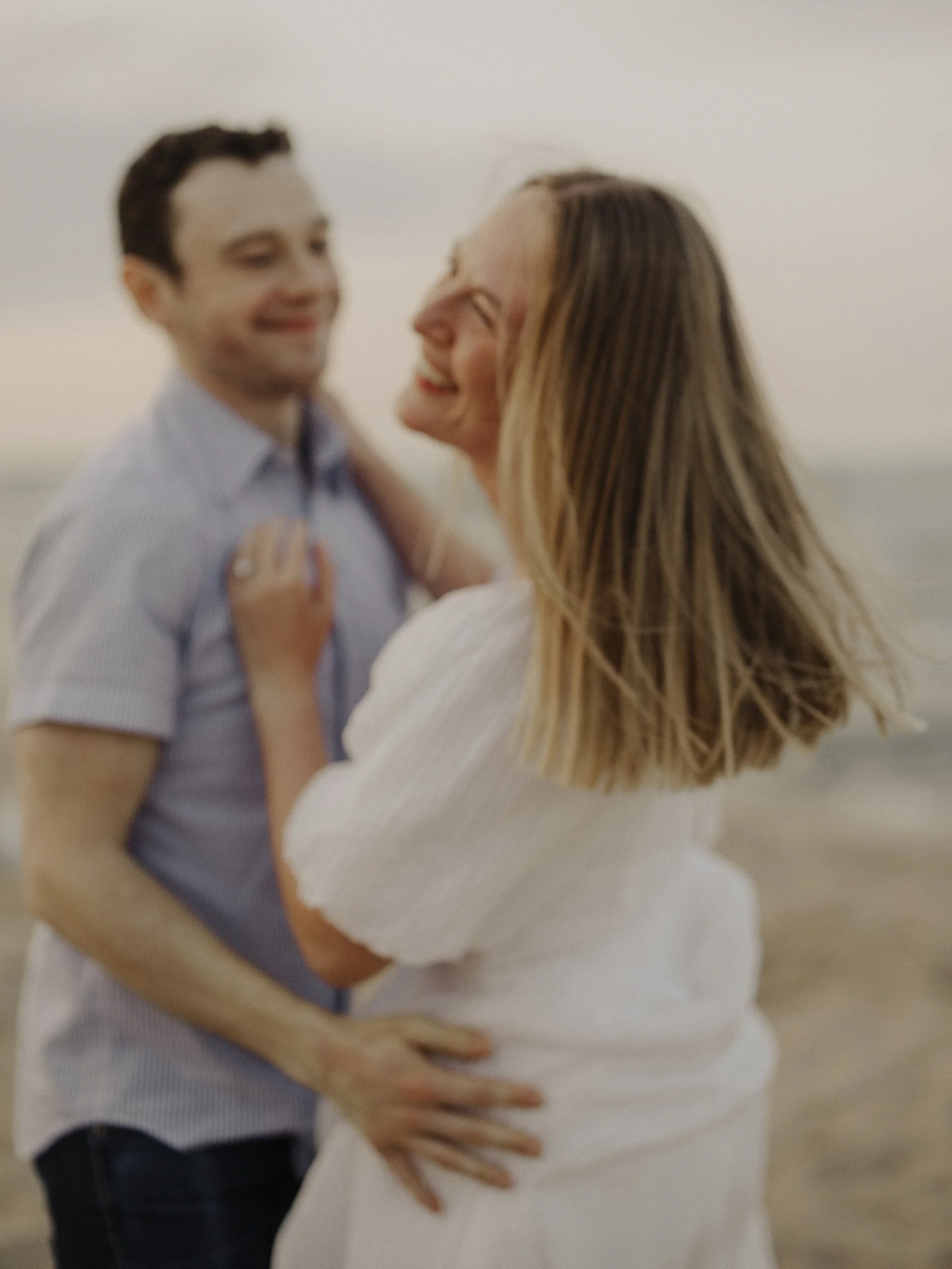 Soft focus couple embracing during engagement session for Chicago wedding photography