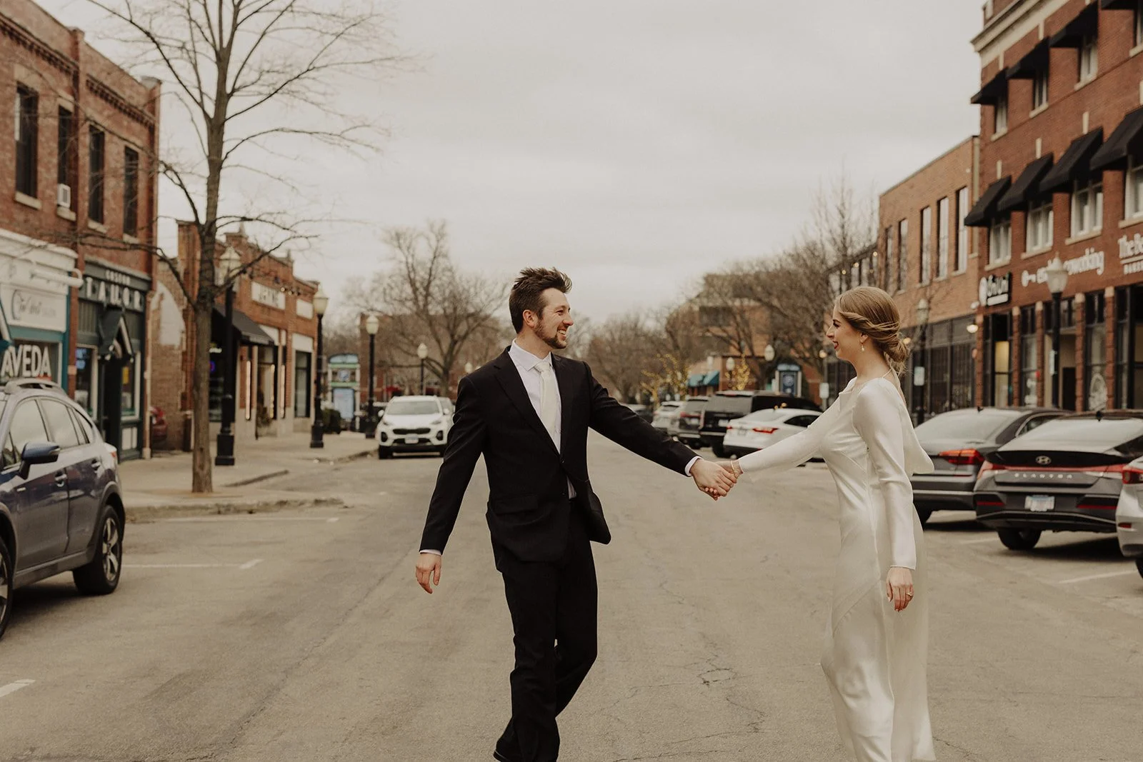 Newlyweds hold hands in the street following their civil ceremony at the elm lagrange il