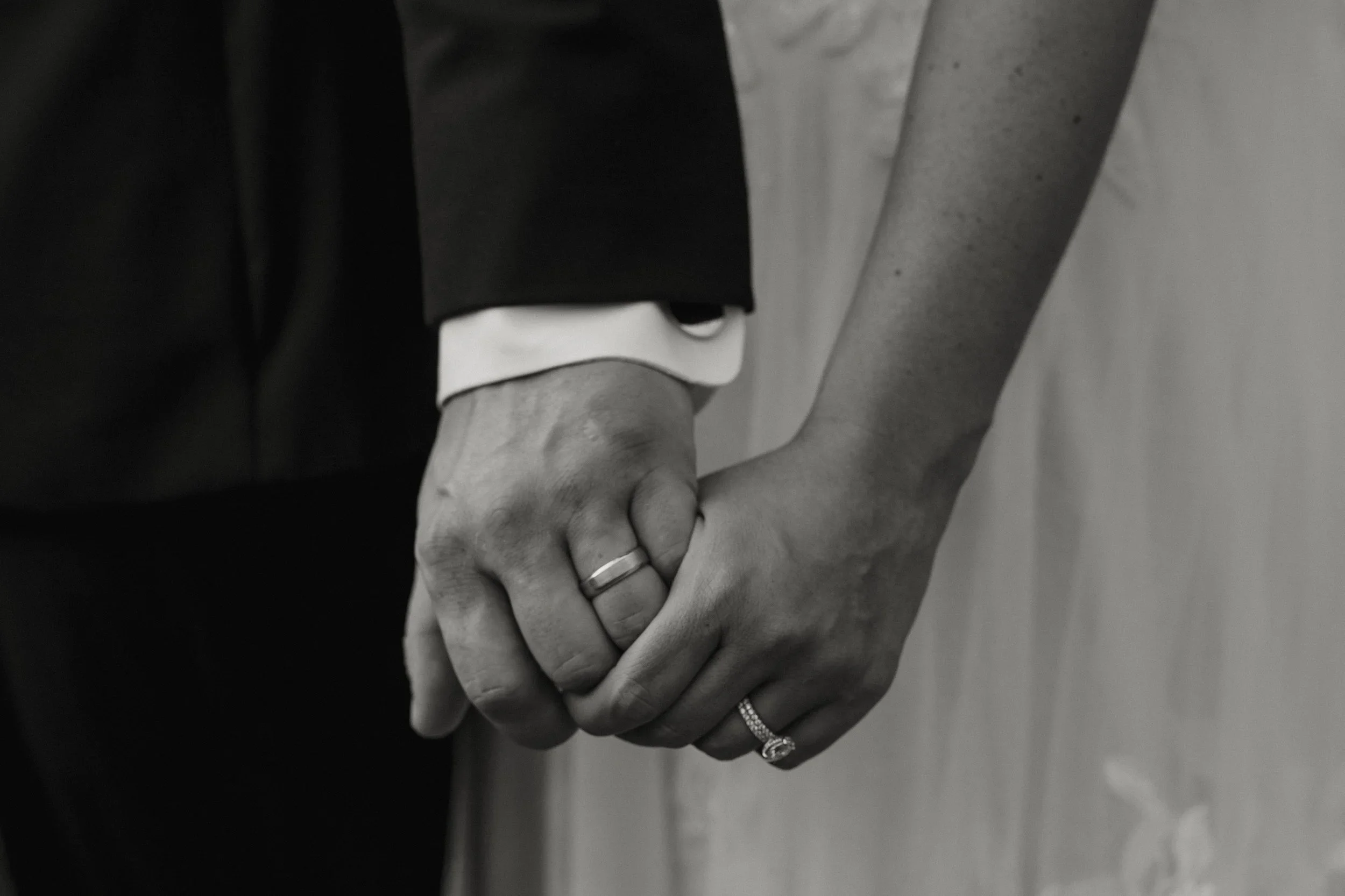 Close up of couple holding hands with wedding rings during Chicago wedding photography session
