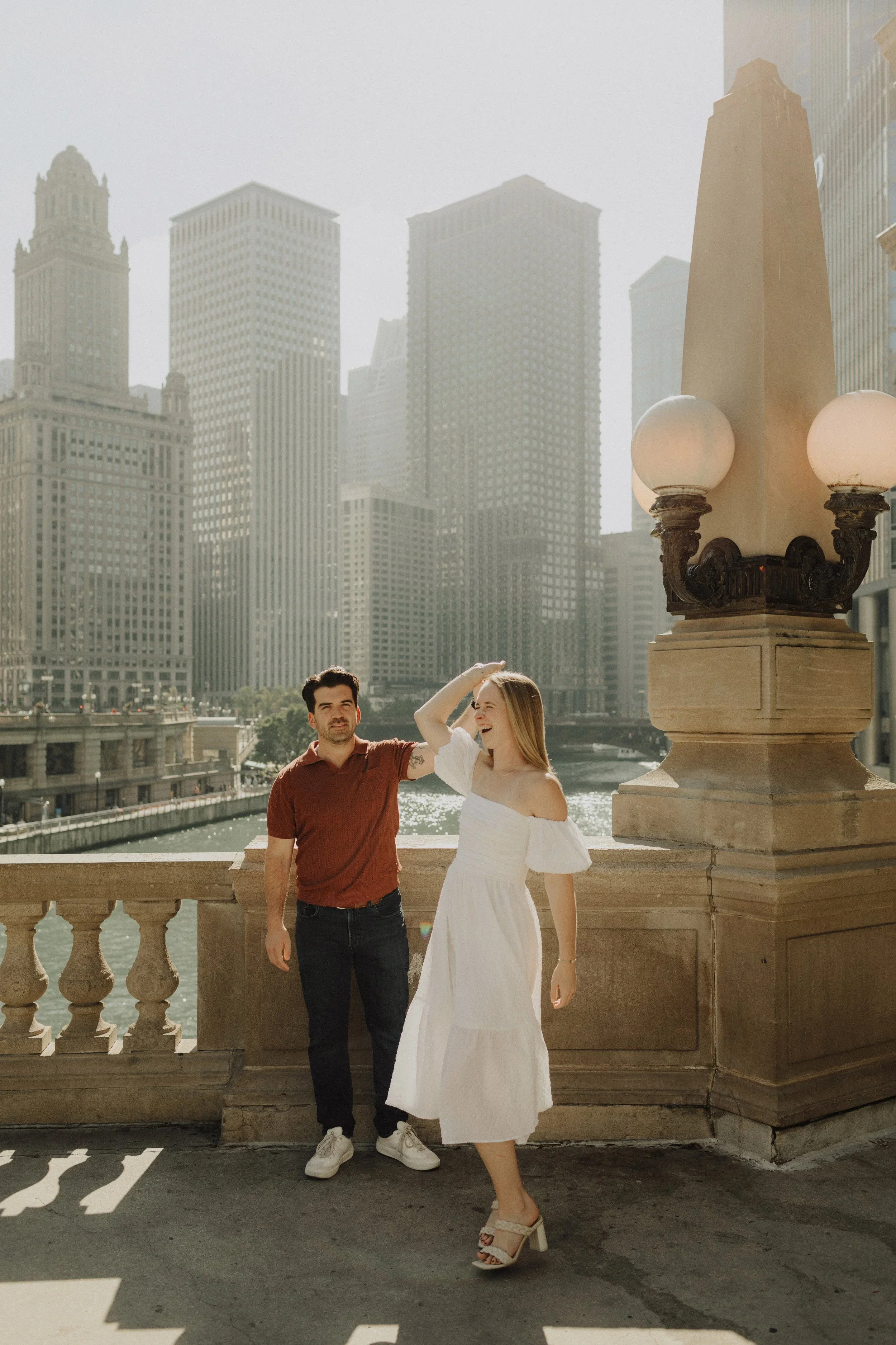 Couple standing by Chicago River skyline during engagement session for Chicago wedding photography