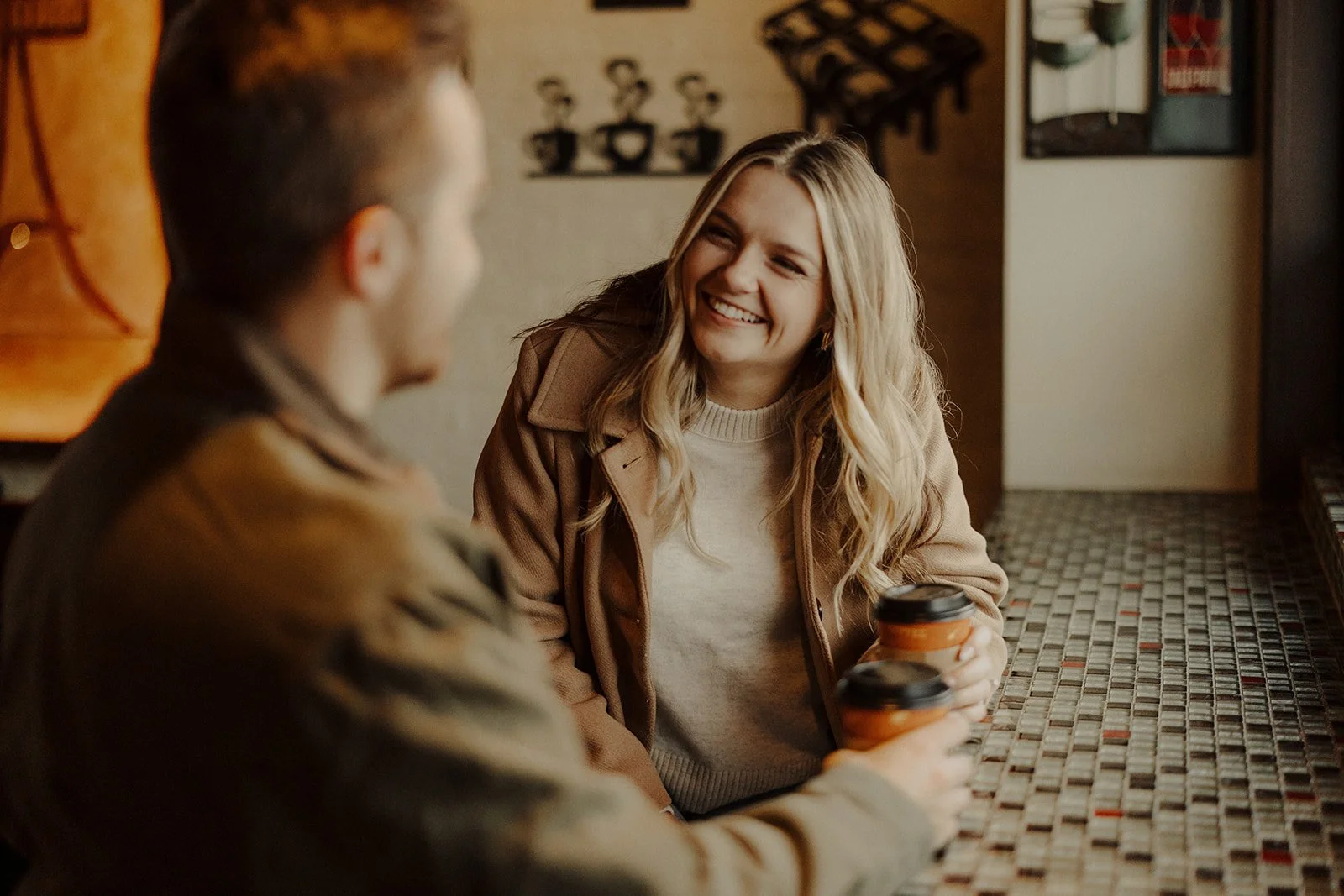 A newly engaged couple share hot chocolate during their engagement photography in Geneva IL