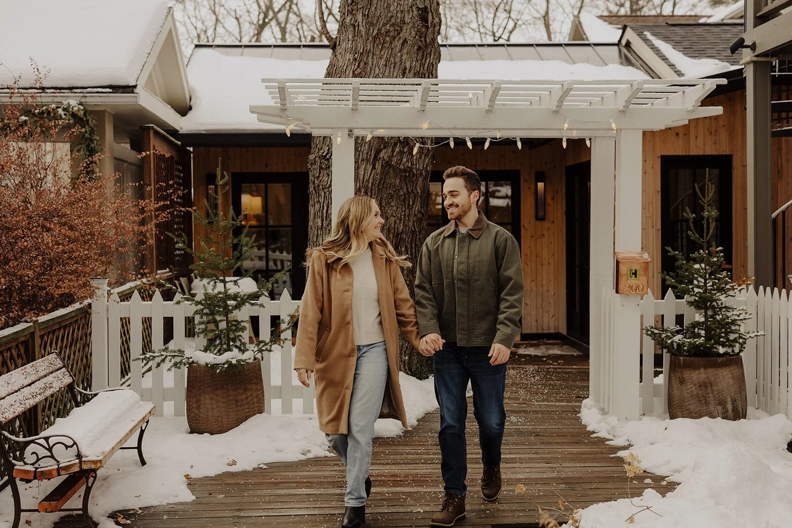 An Illinois couple hold hands during winter engagement photography in Geneva IL