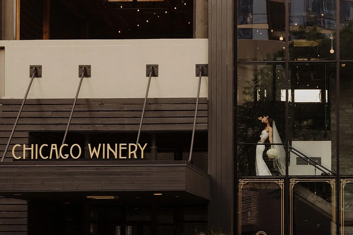 Newlyweds are photographed through the window of The Chicago Winery