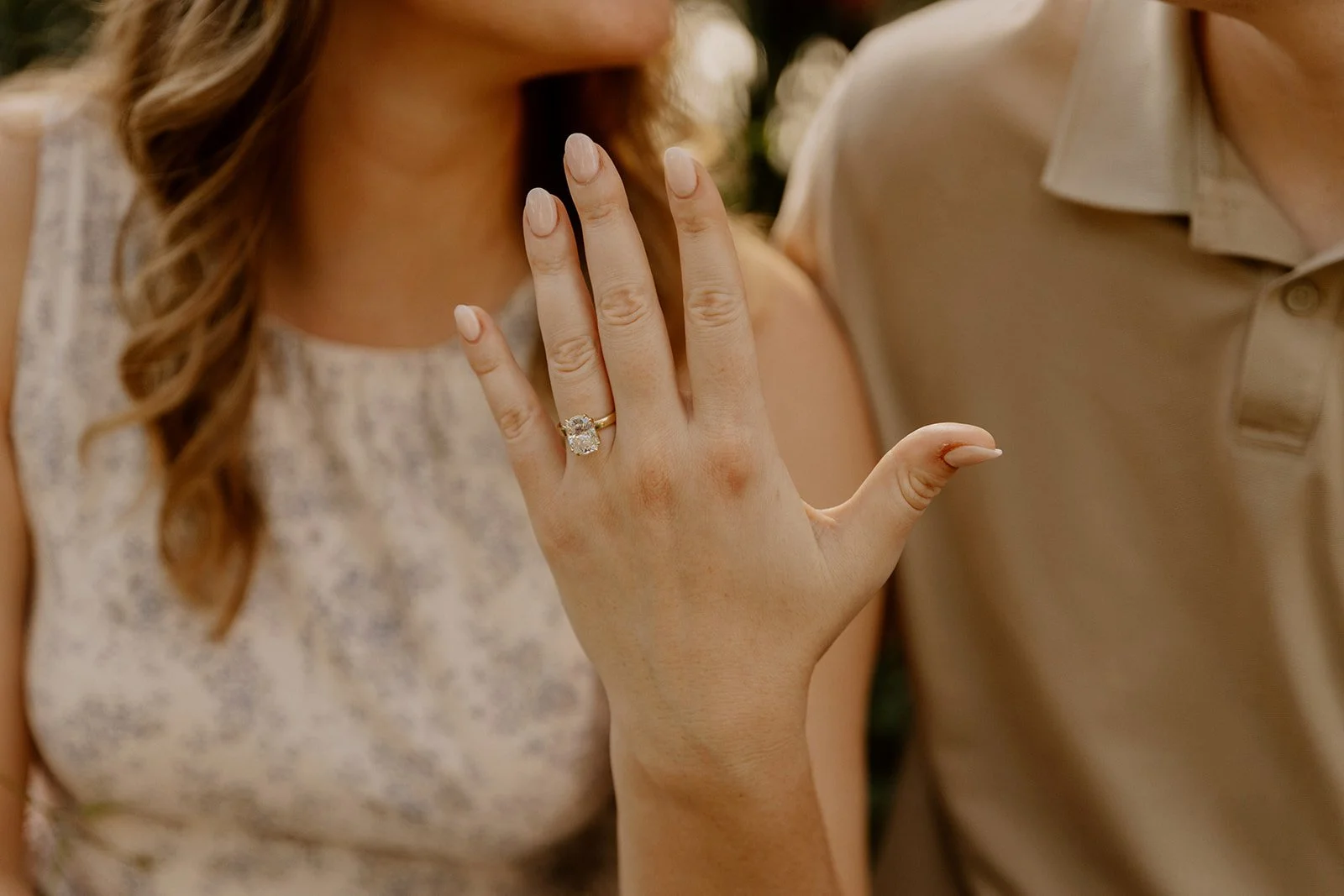 A close up image taken during a Chicago botanic garden engagement photoshoot showcases a diamond solitaire ring on a gold band.