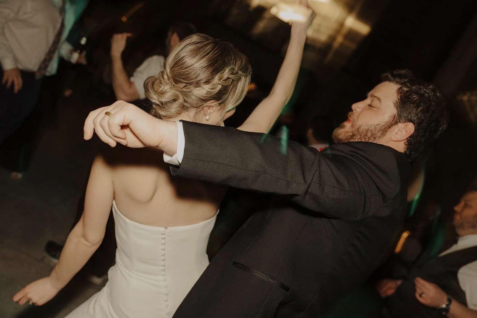 Newlyweds dance with guests at their Pazzos 311 Chicago wedding reception.